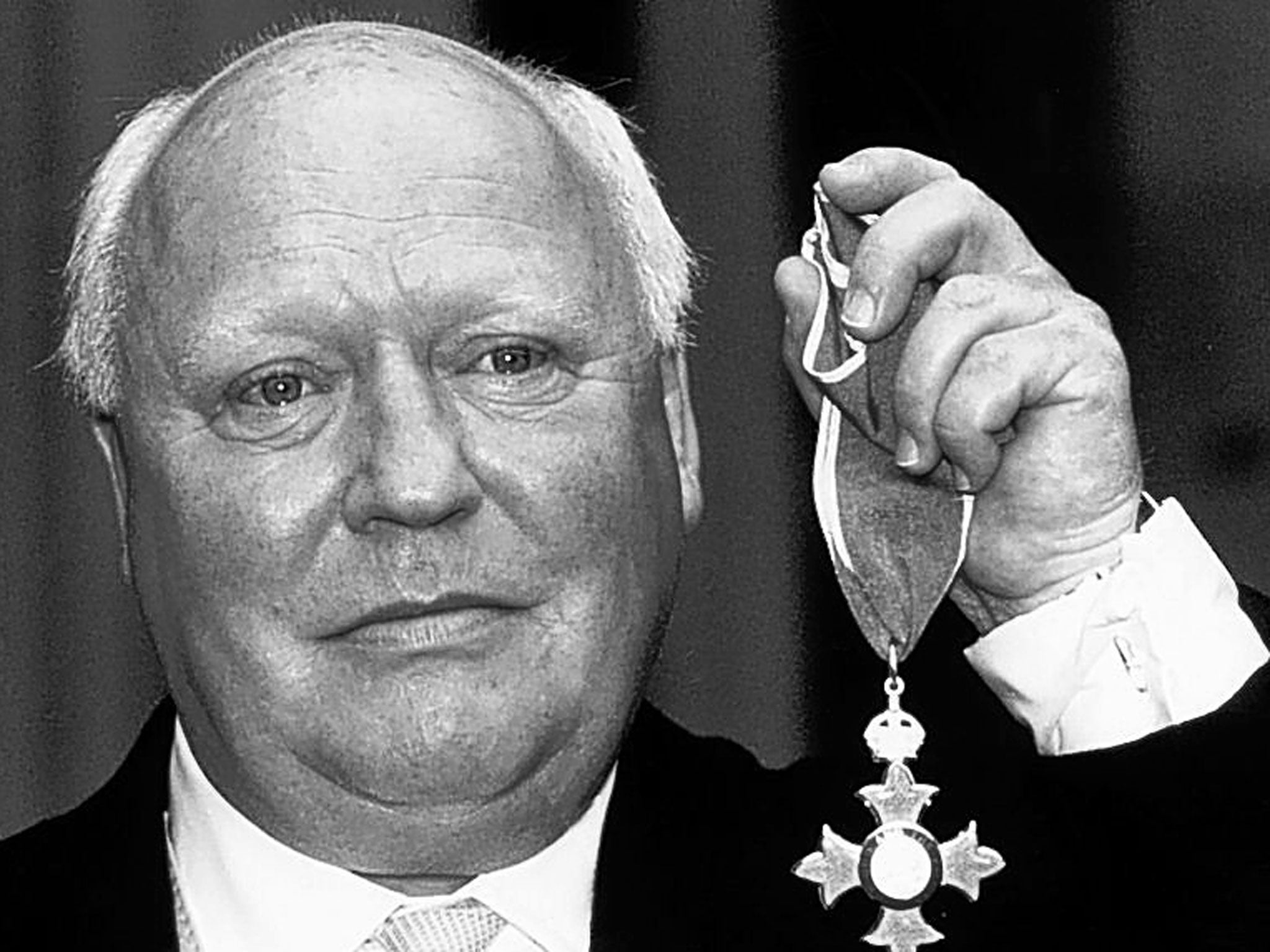 Hitchen receives his CBE in 1990; he later served on the Media Honours Committee