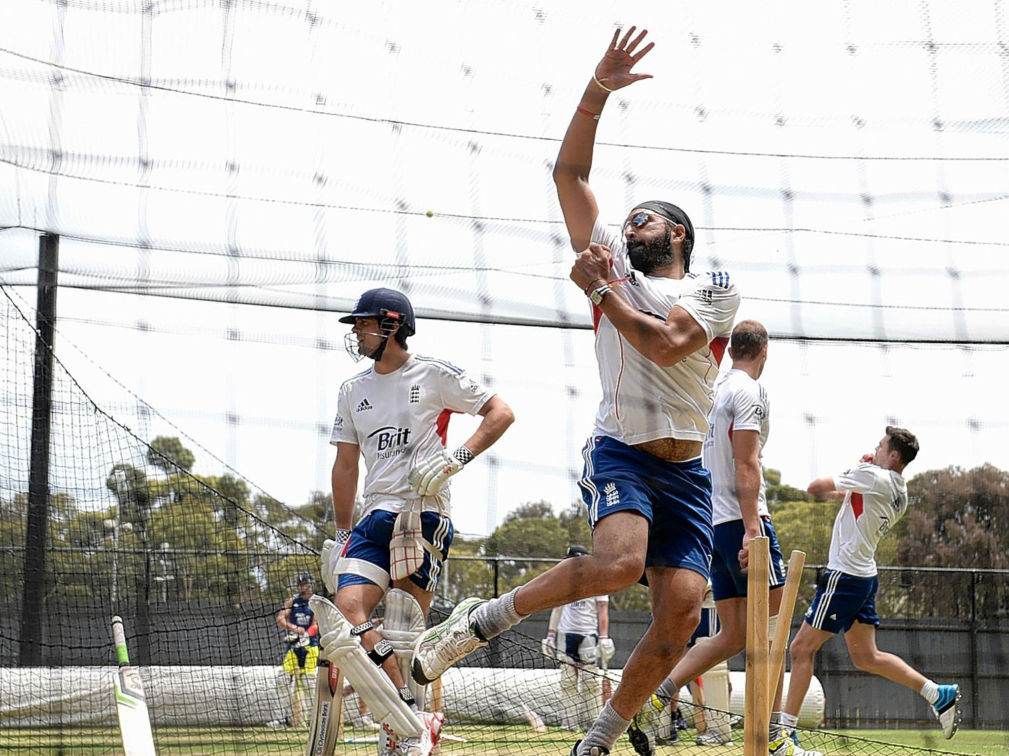 Monty Panesar bowls in the nets at Adelaide as Alastair Cook looks on