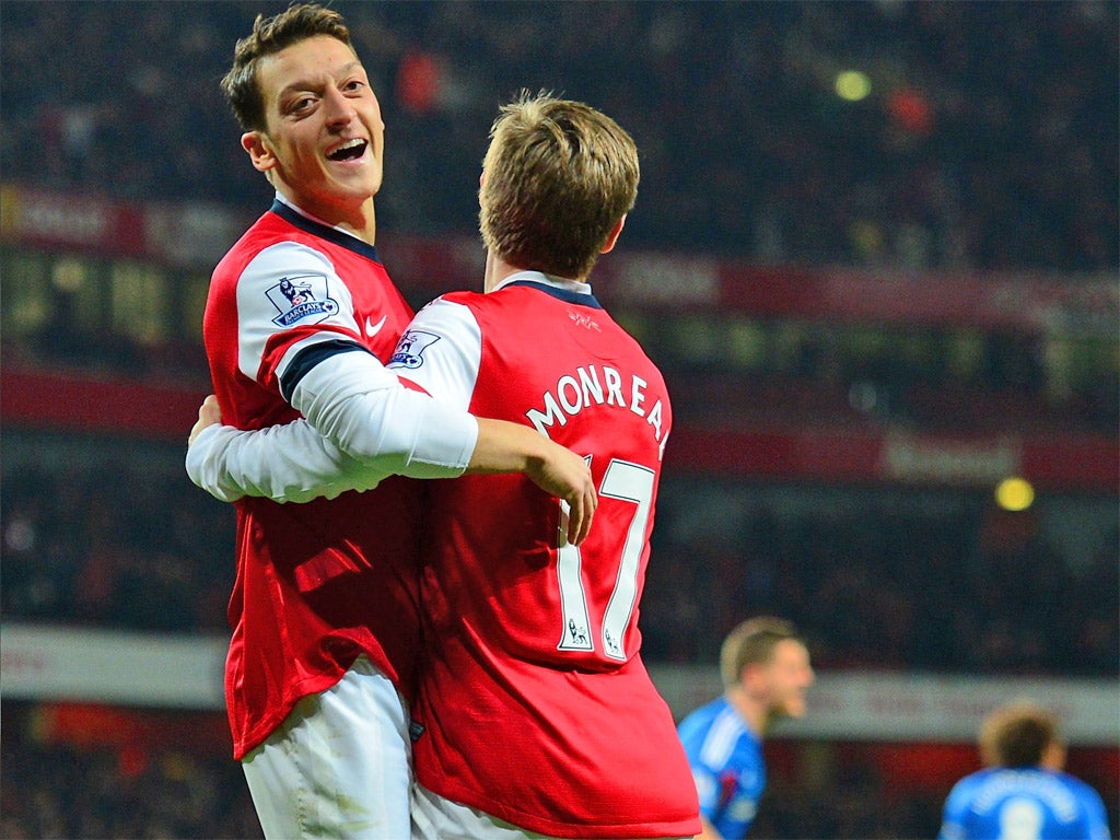 Mesut Ozil celebrates his goal with its provider, Nacho Monreal