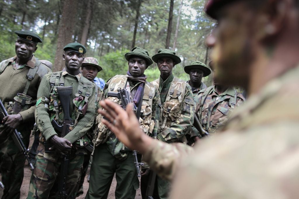 Rangers listen as a British paratrooper gives them direction