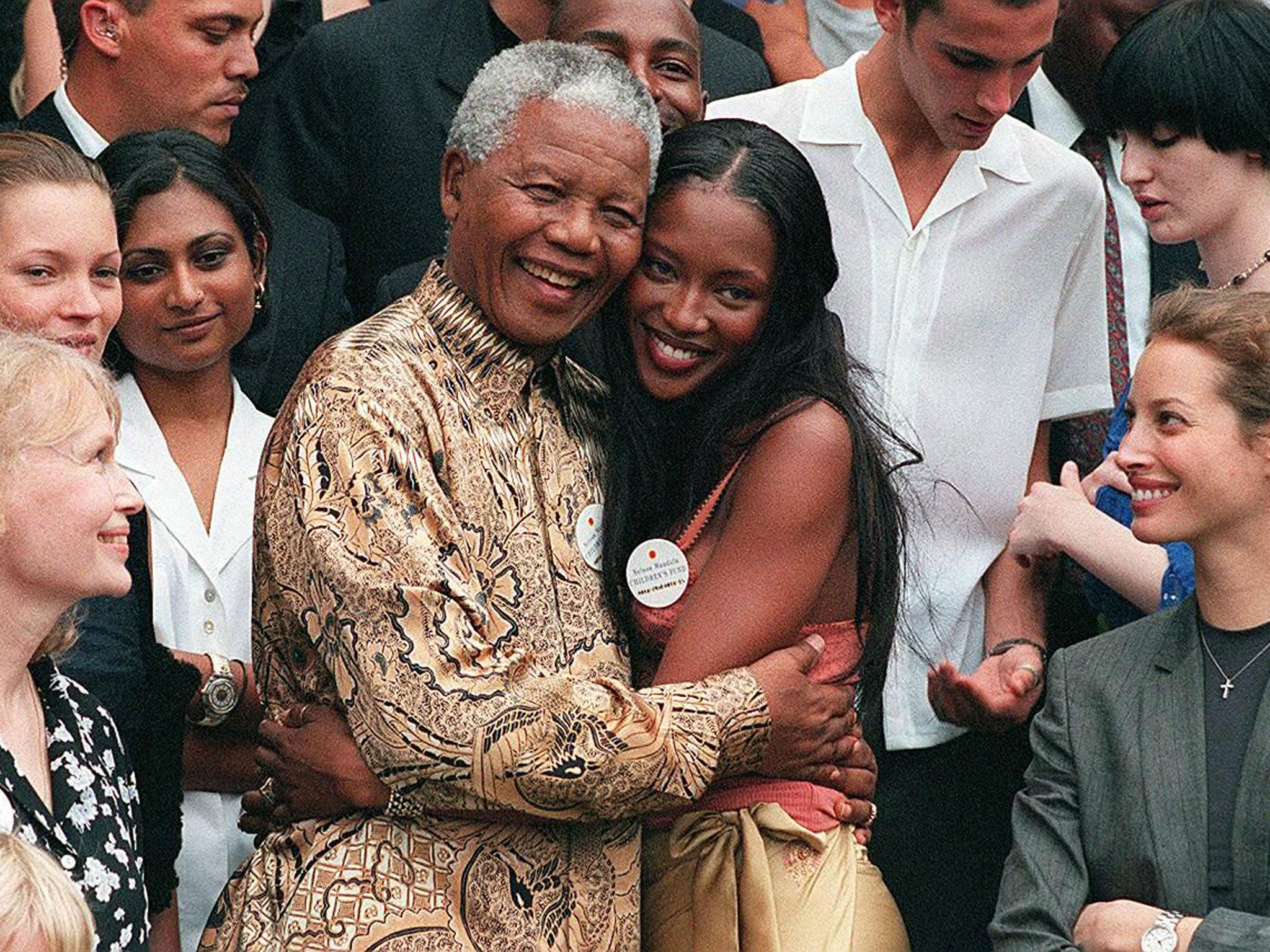 February 1998: Nelson Mandela (L) hugs British supermodel Naomi Campbell in front of American actress Mia Farrow, British model Kate Moss (second from left) and model Christy Turlington (AFP)