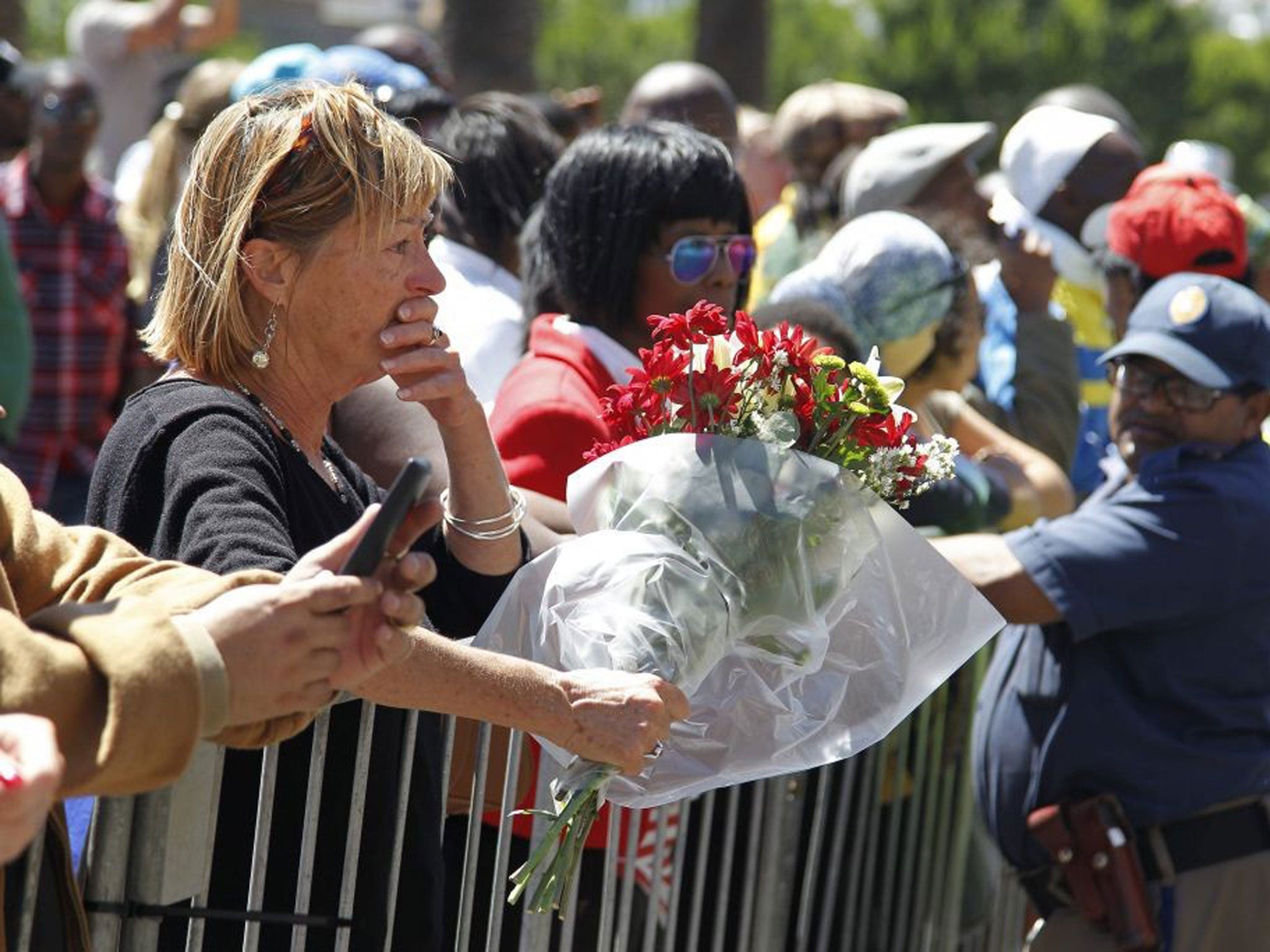 South African mourners gather in front of the Cape Town City Hall where the late South African president Nelson Mandela made his first public address after being released in Cape Town, South Africa