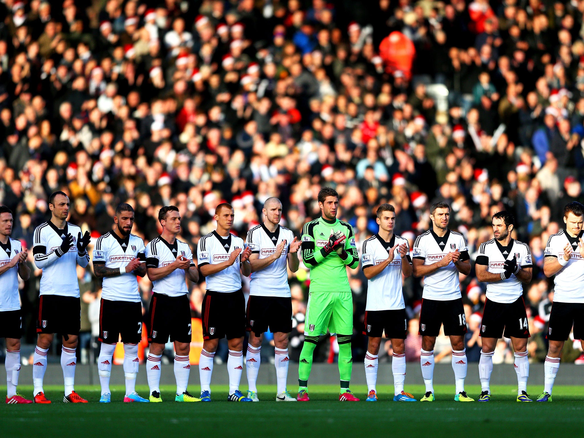 The Fulham players take part in a minutes applause in remembrance of Nelson Mandela