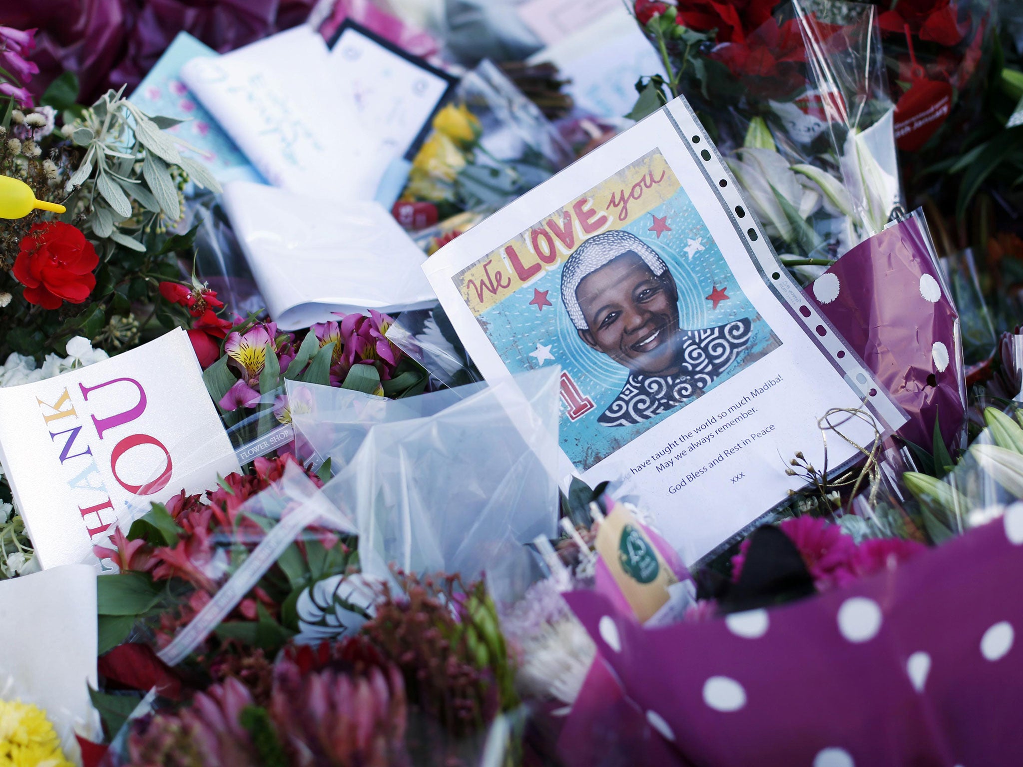 Mandela’s statue in London’s Parliament Square, adorned with flowers, messages and a flag