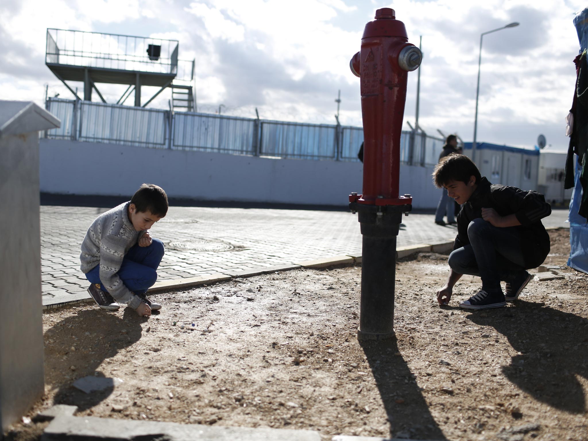 Young Syrian refugees from Jisr al Shugour play at the 'Container City' refugee camp