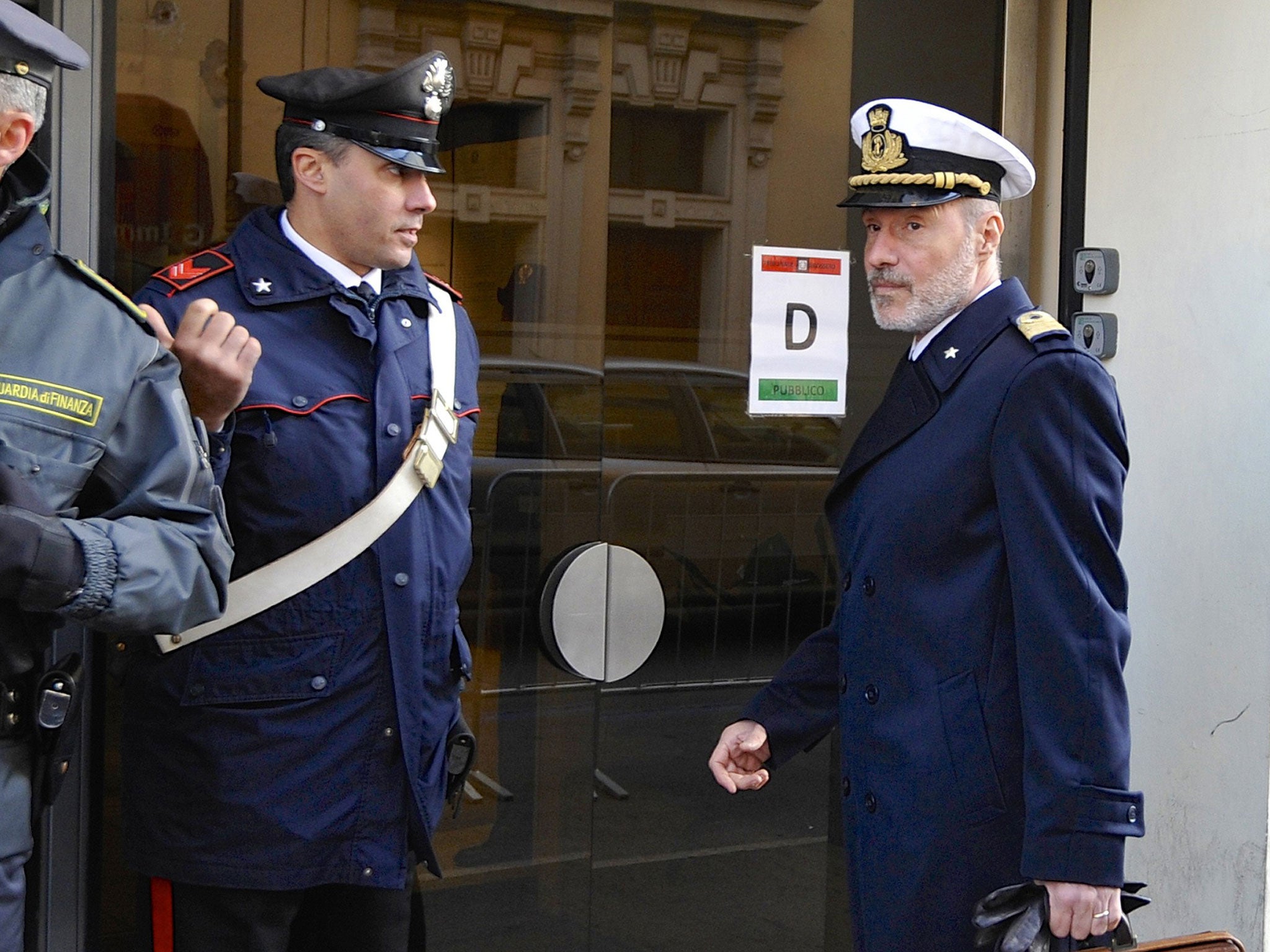 Coast Guard Captain Gregorio De Falco, right, arrives at the Grosseto court - the court was told hundreds of people were still aboard the shipwrecked Costa Concordia when the commander abandoned the cruise liner in a lifeboat