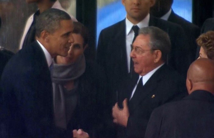 President Barack Obama shakes hands with Cuban President Raul Castro at the memorial service for Nelson Mandela