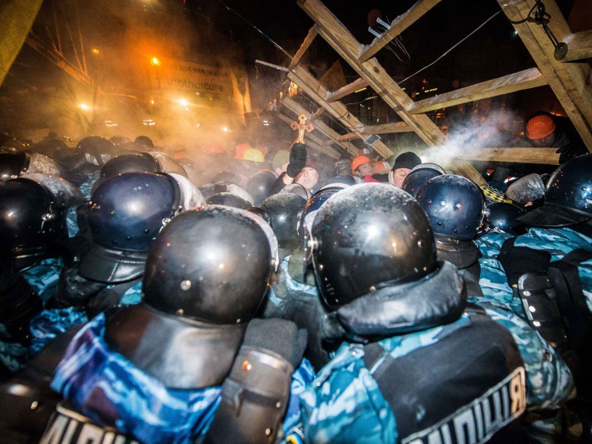 Riot police assault a barricade held by protesters on Independence Square in Kiev late on 11 December, 2013