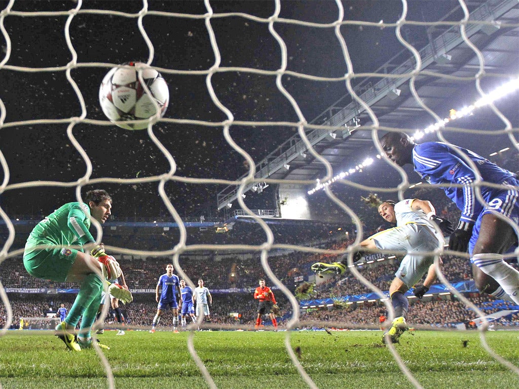 Demba Ba (right) gets the final touch in a tussle with Steaua’s Daniel Georgievski to give Chelsea an early lead