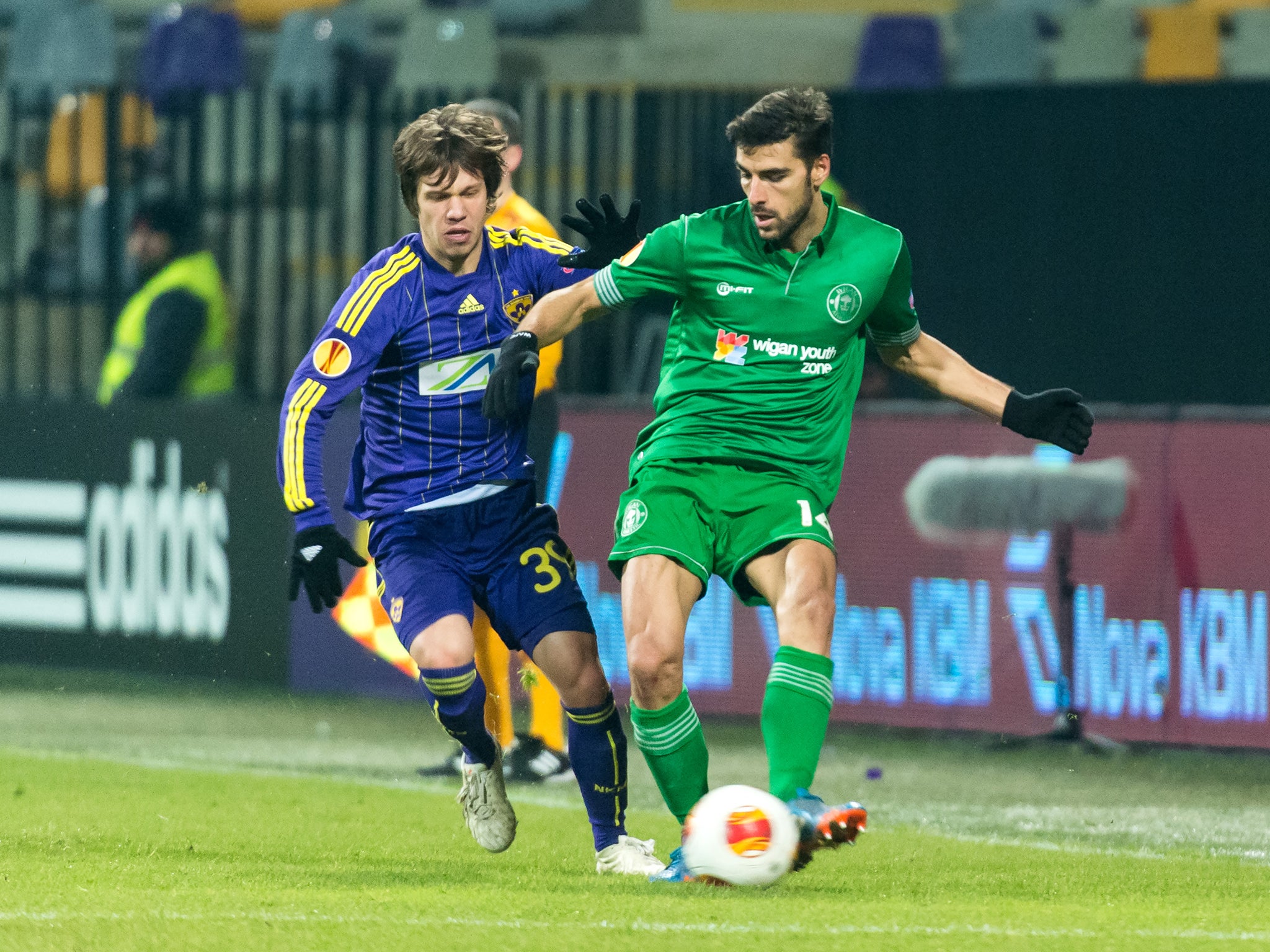 Wigan midfielder Jordi Gomez battles with Maribor's Damjan Bohar