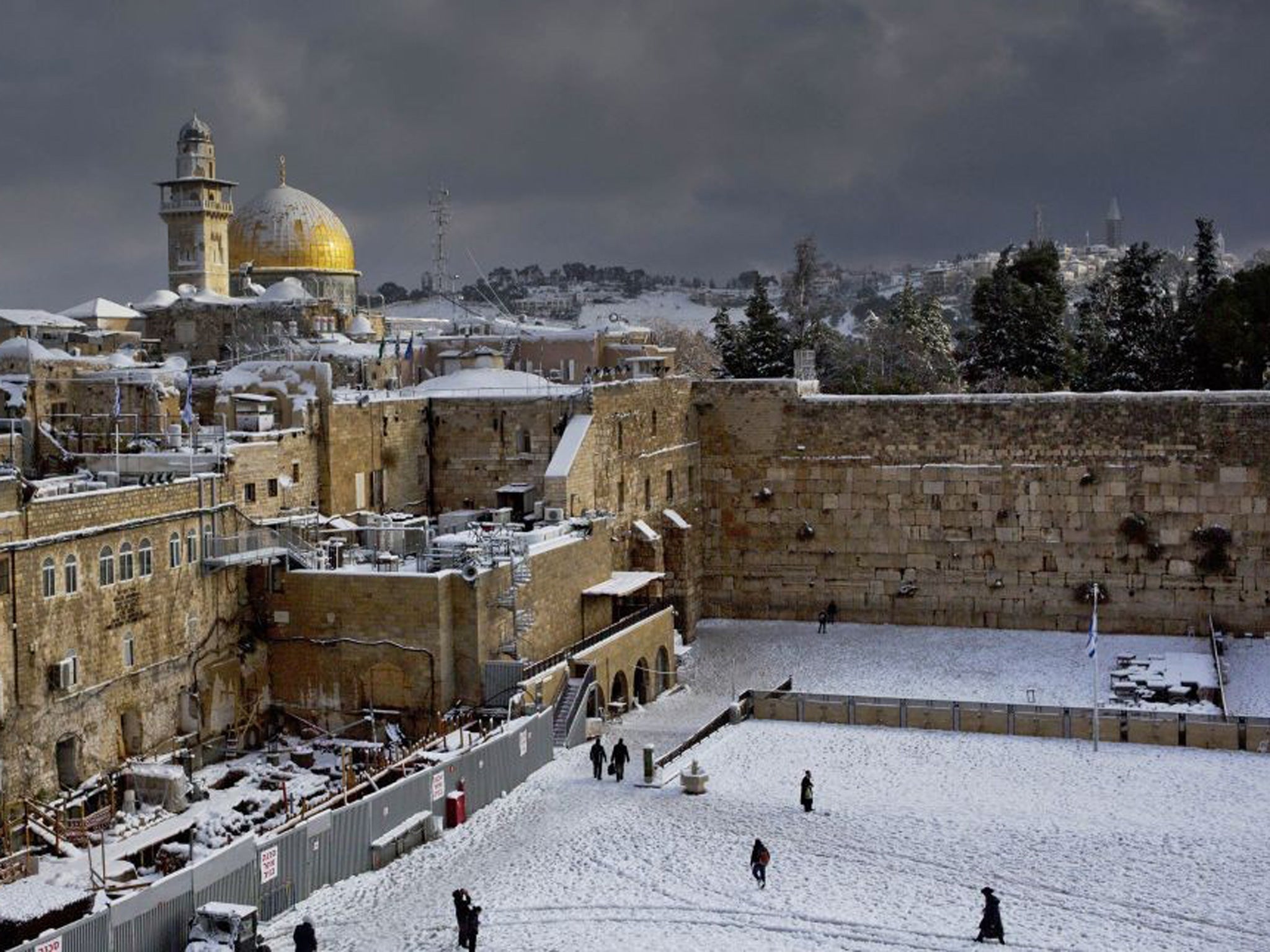 Western Wall and the Dome of the Rock, some of the holiest sites for for Jews and Muslims, are covered in snow in Jerusalem on 13 December 2013