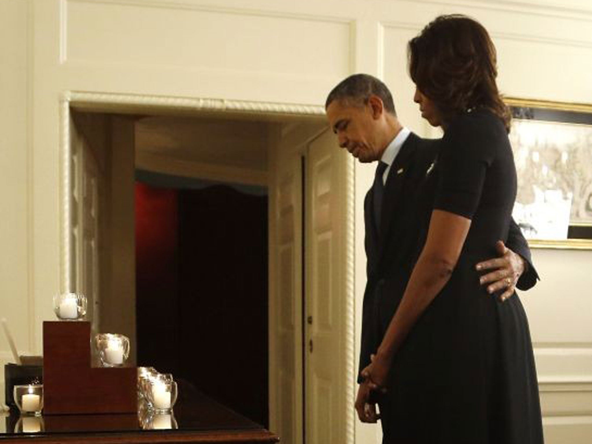 One year on: The President and Mrs Obama observe a minute’s silence for the Sandy Hook massacre