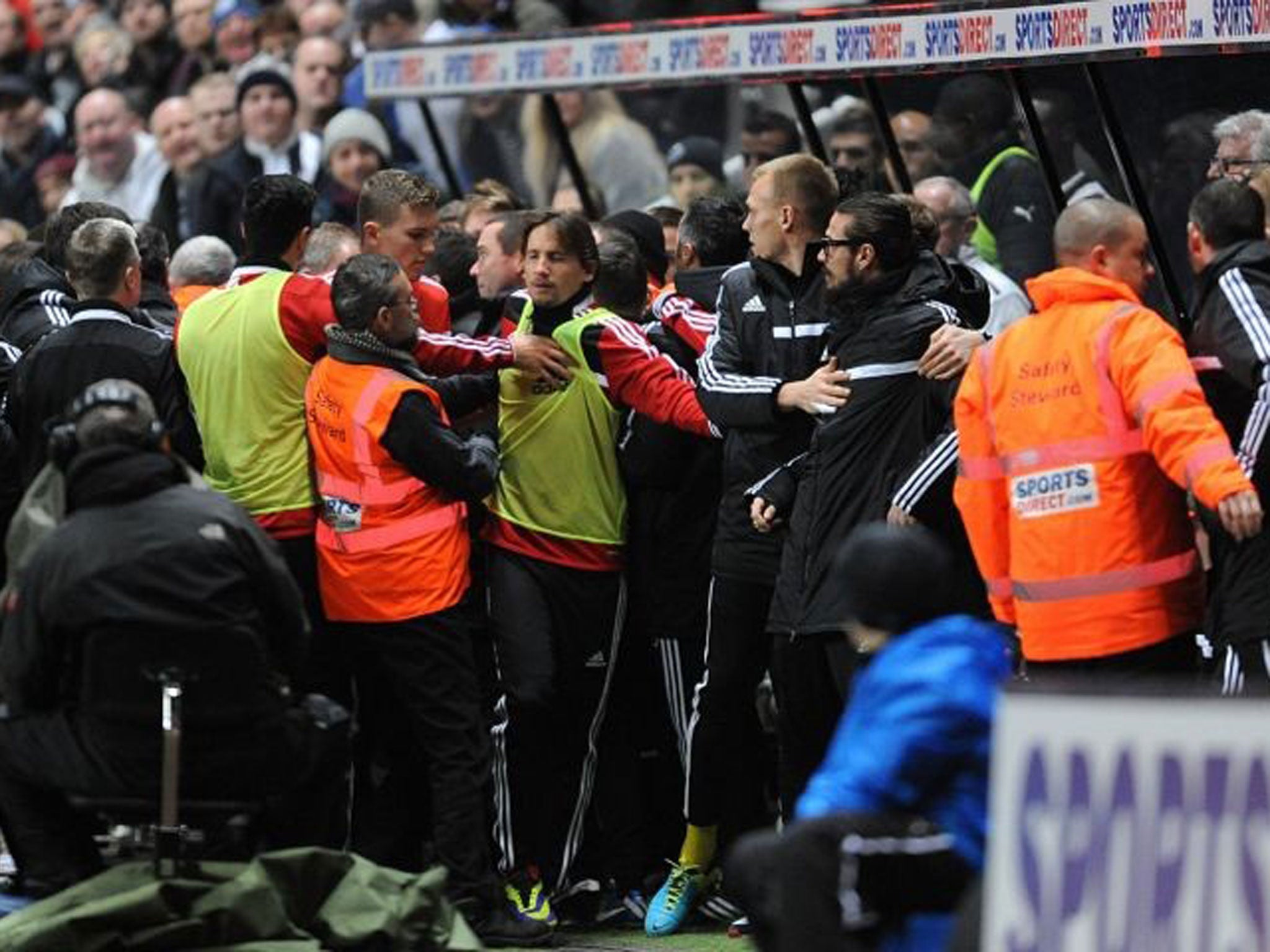 Scrappy draw: Stewards intervene to stop a scuffle among coaching staff that cleared the dug-outs at St James’ Park