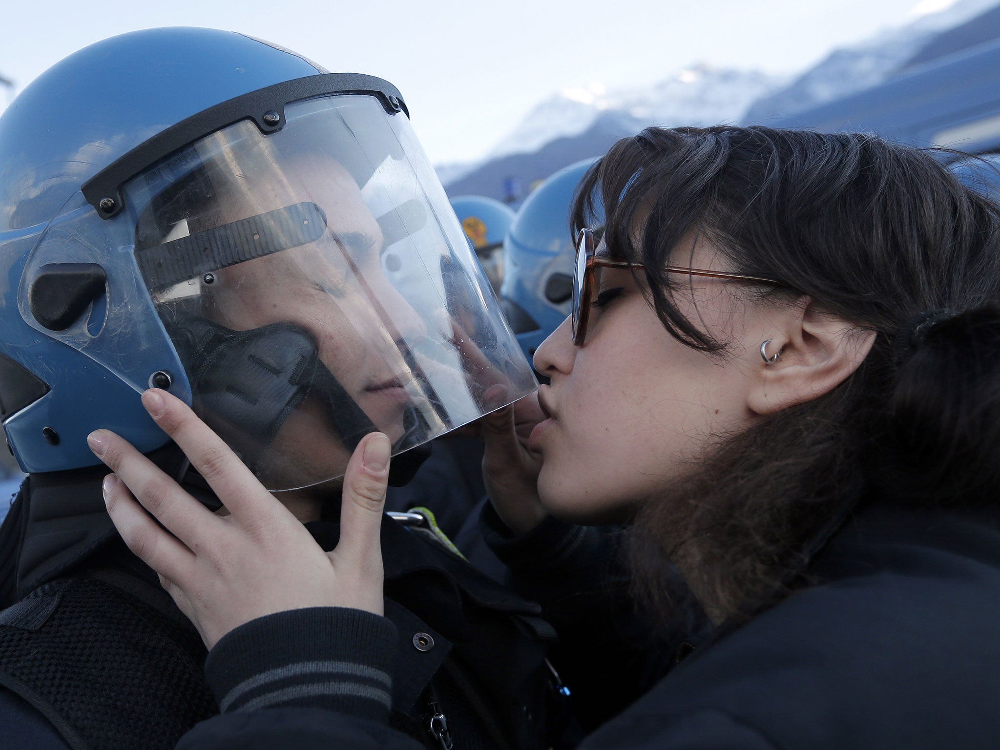 The 20-year-old student was photographed kissing officer Salvatore Piccione during a protest against a planned rail link in Northern Italy.