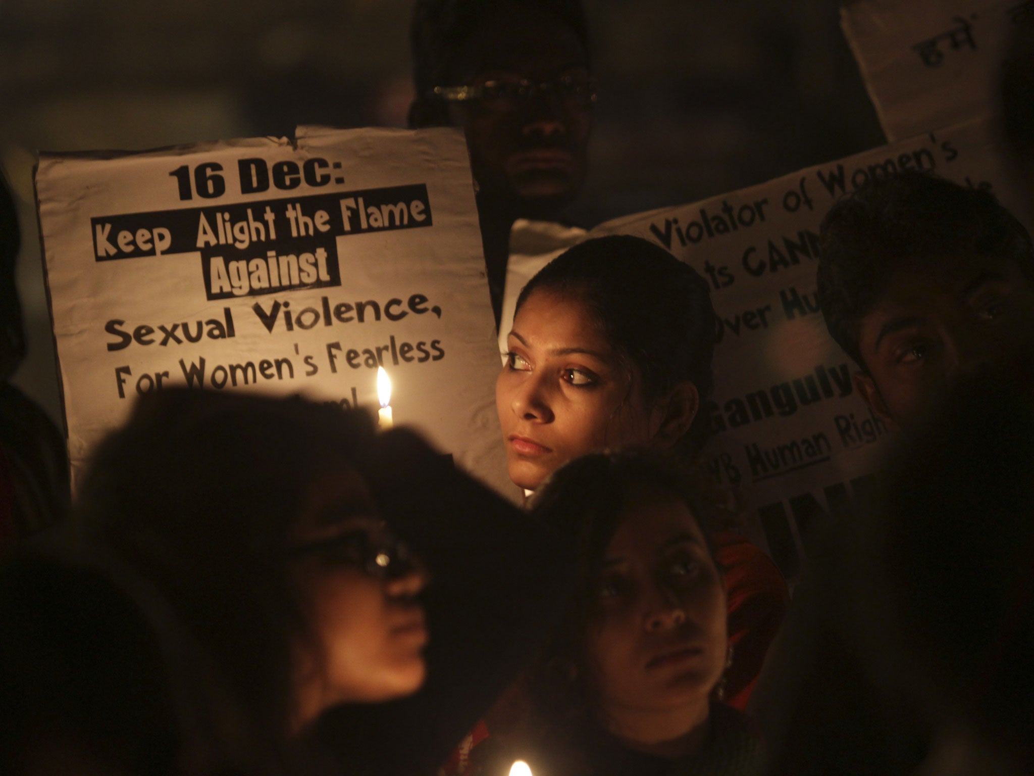 Indians students from the Jawaharlal Nehru University hold placards during a candle light vigil on the first anniversary of the fatal gang rape of a young woman in a bus