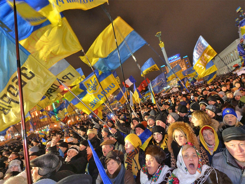 Ukrainian protesters shout slogans during a mass opposition rally in Independence Square in Kiev