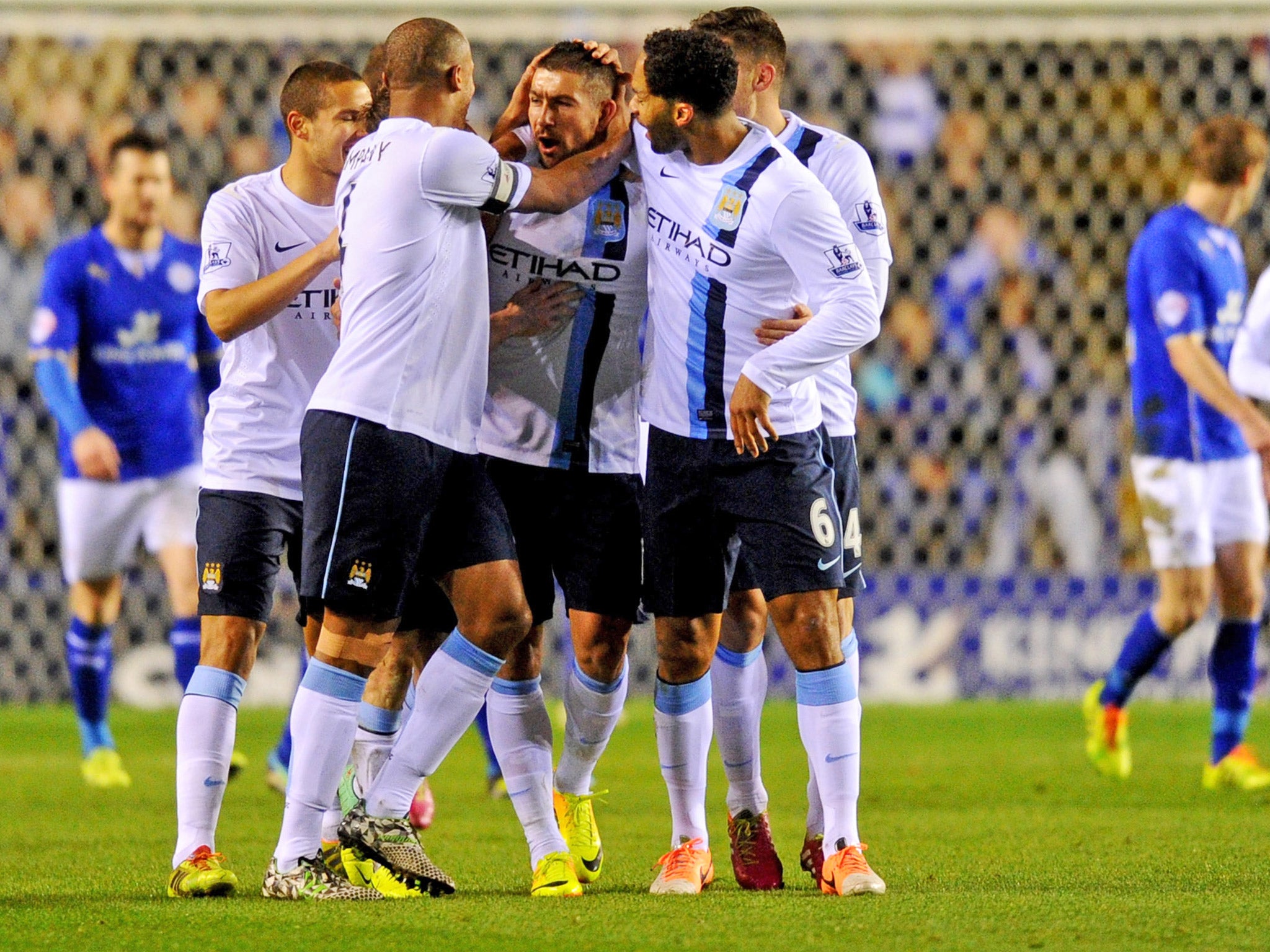 Teammates gather to congratulate Aleksandar Kolarov after he gave Manchester City the lead