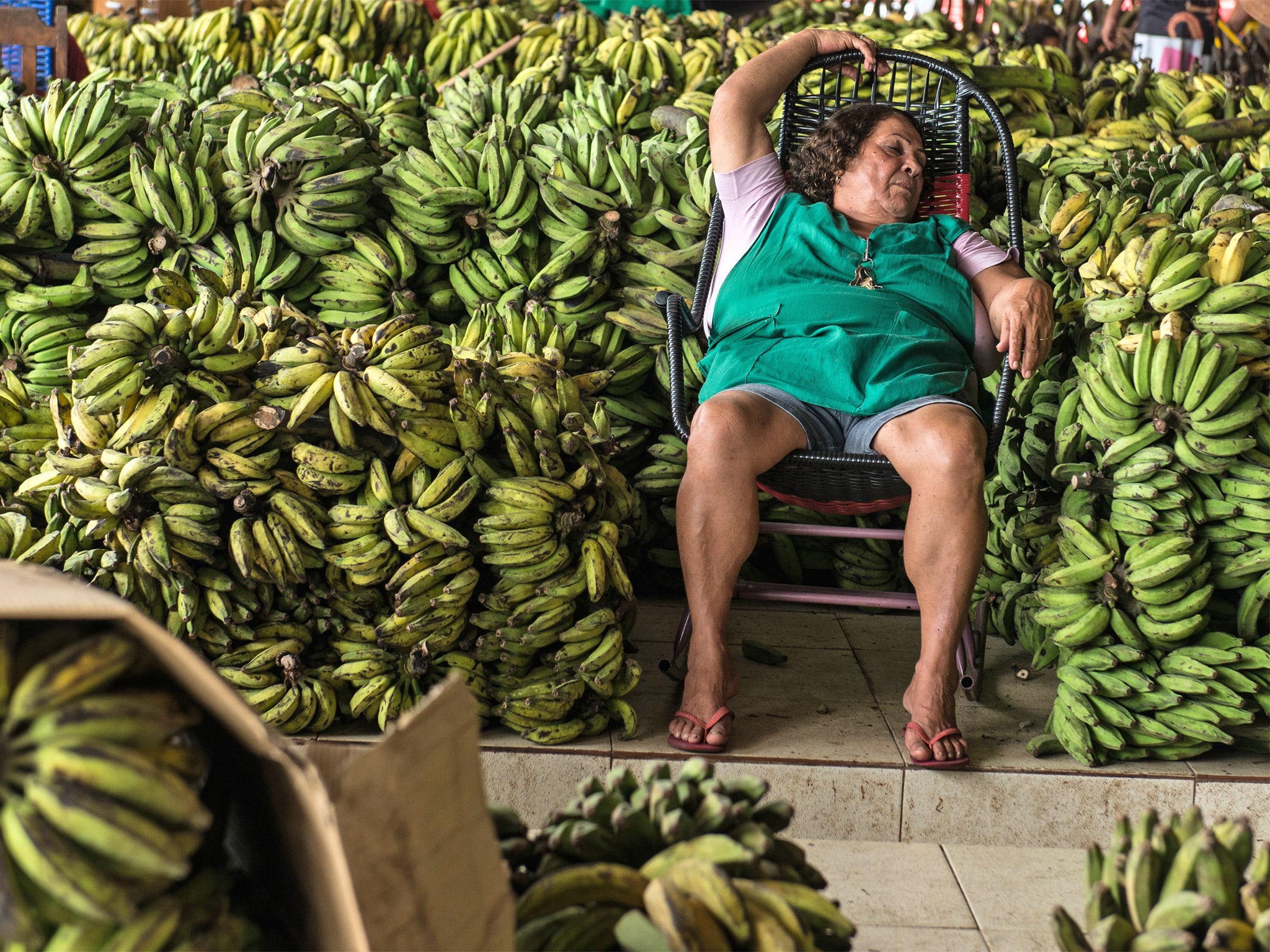 Banana-nap: a woman rests at her banana stall in Manaus, Brazil