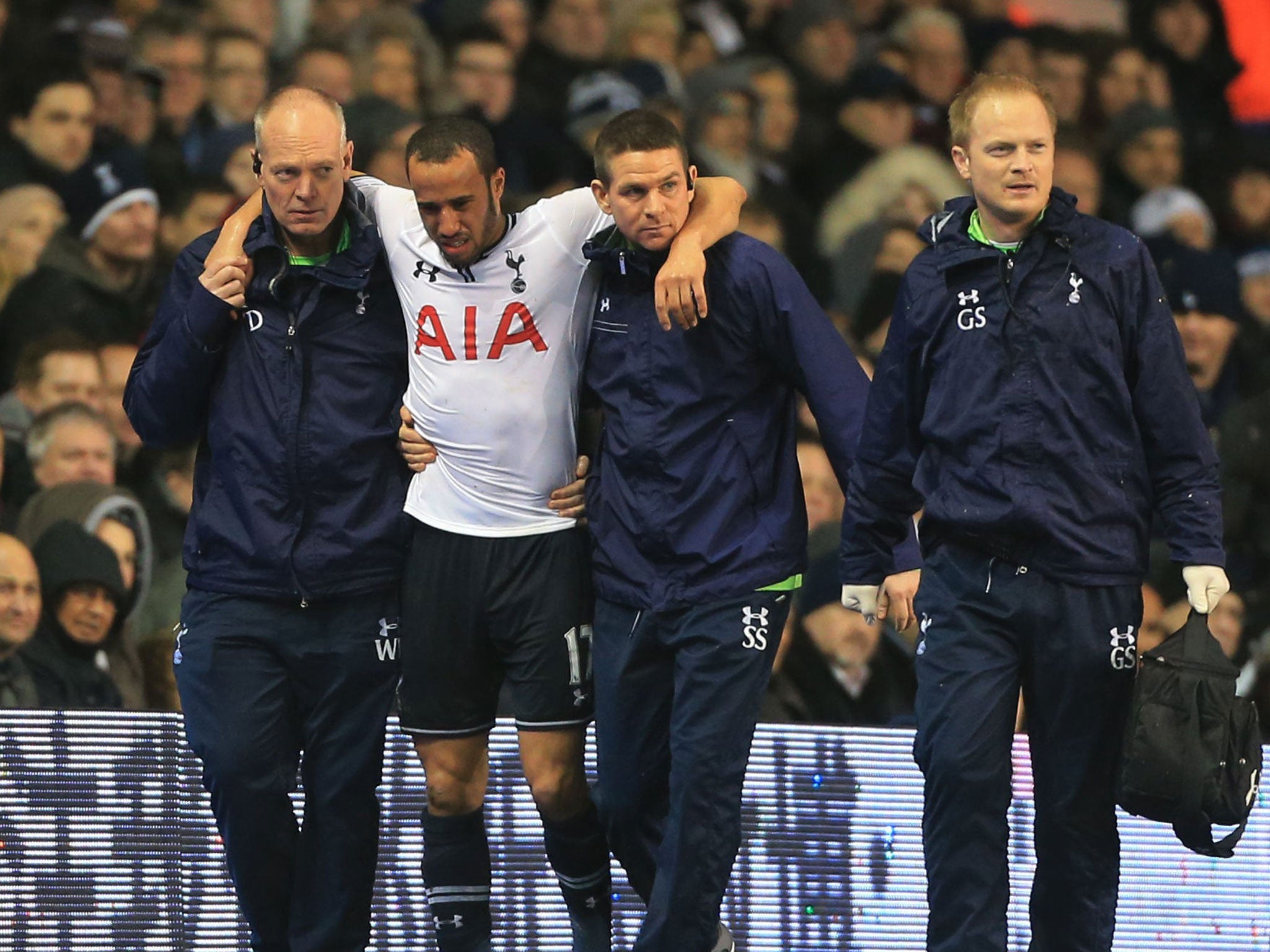 Andros Townsend is helped from the White Hart Lane pitch but his injury is not as bad as first feared