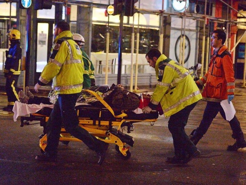 Paramedics attend to an injured person at the scene