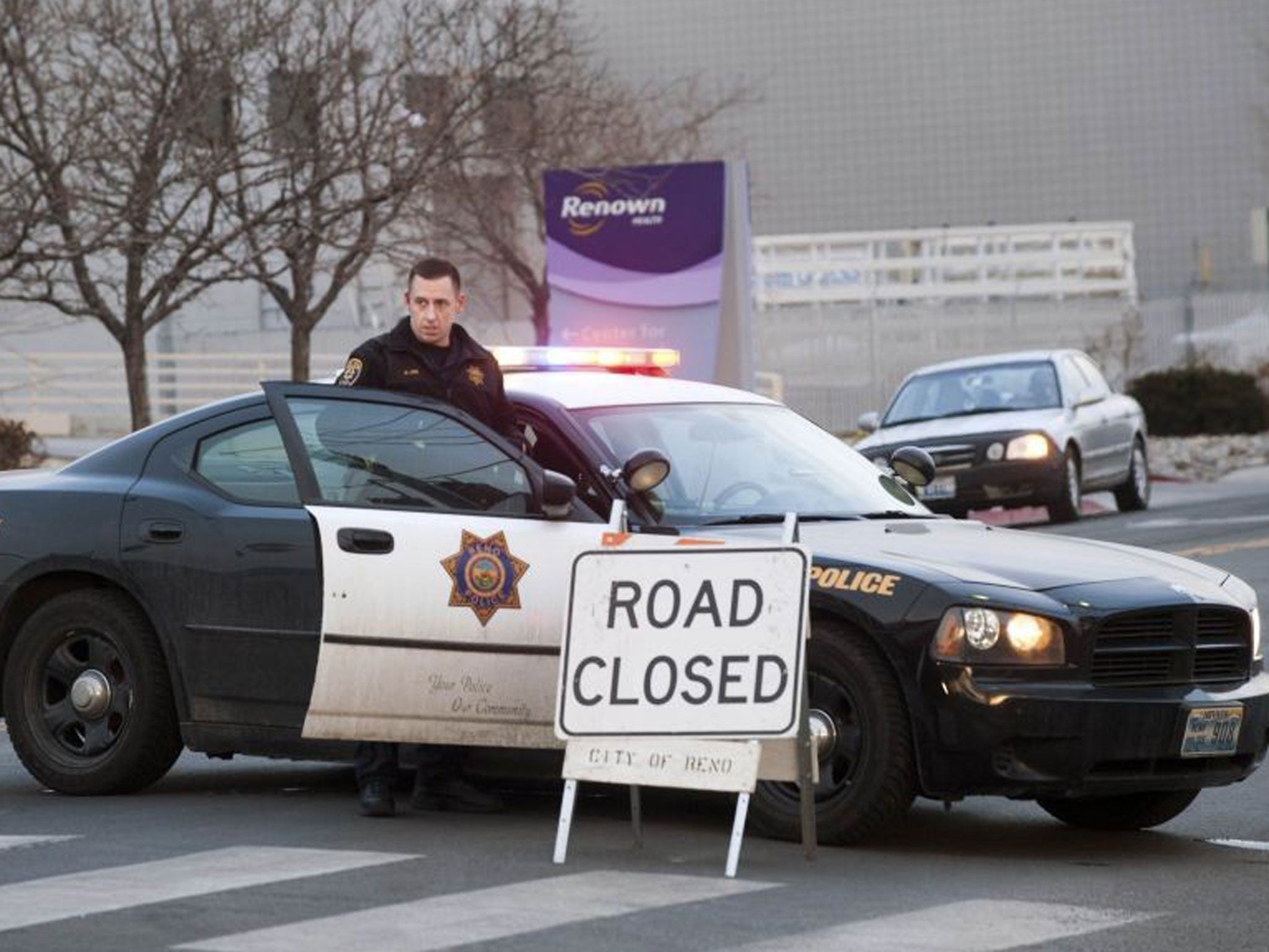 Reno Police guards the entrance of the Renown Regional Medical Center during a lockdown in Reno, Nevada December 17, 2013. A man opened fire on Tuesday in a Reno, Nevada, medical building, killing one person and injuring two others before he died of an ap