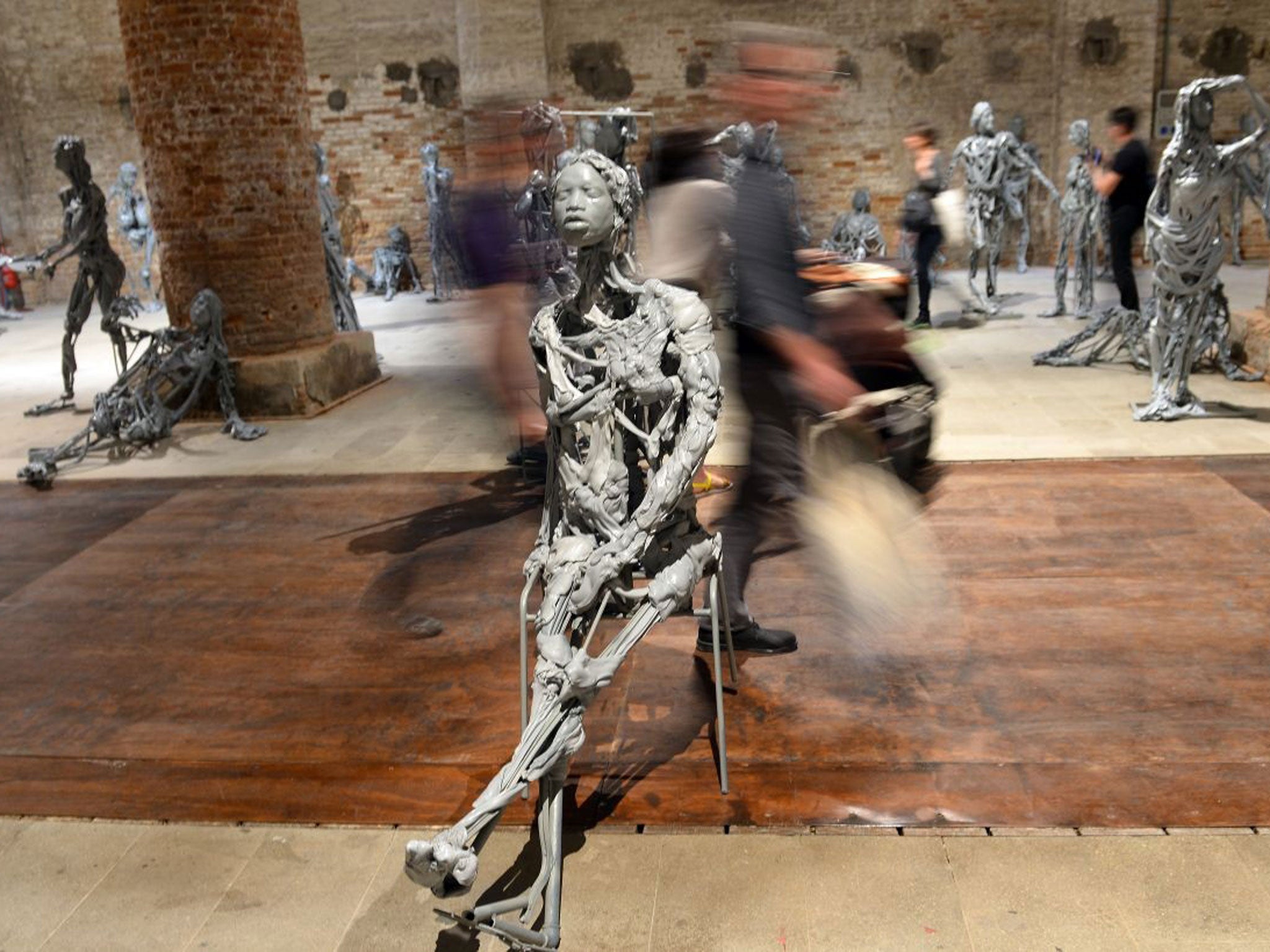 Visitors walk in the Encyclopedic Palace exhibition during the press preview of the 55th Venice art biennale