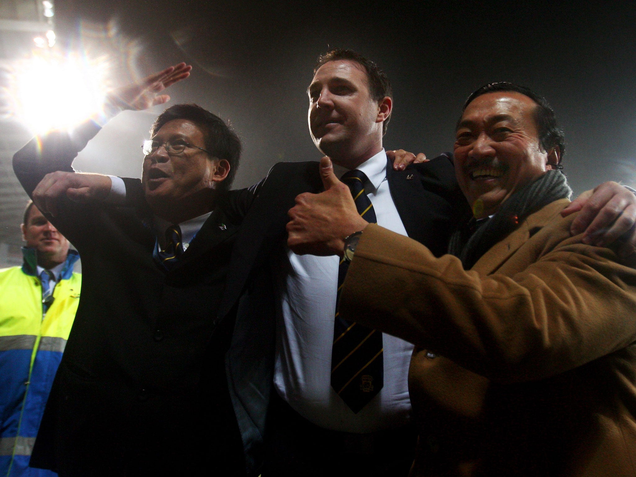 Vincent Tan (right) in happier times with Malky Mackay (centre) as they celebrate a Cardiff victory
