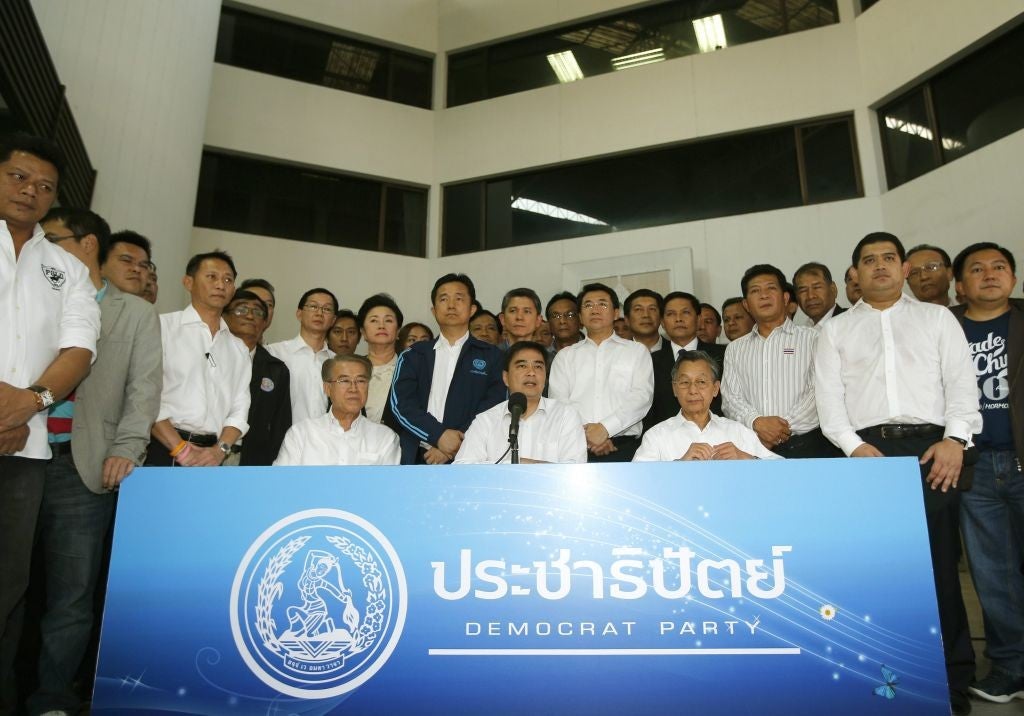 Thai opposition Democrat Party's leader Abhisit Vejjajiva (front C) and members party, speaks to media during a press conference at the party headquarters in Bangkok, Thailand, 21 December 2013.