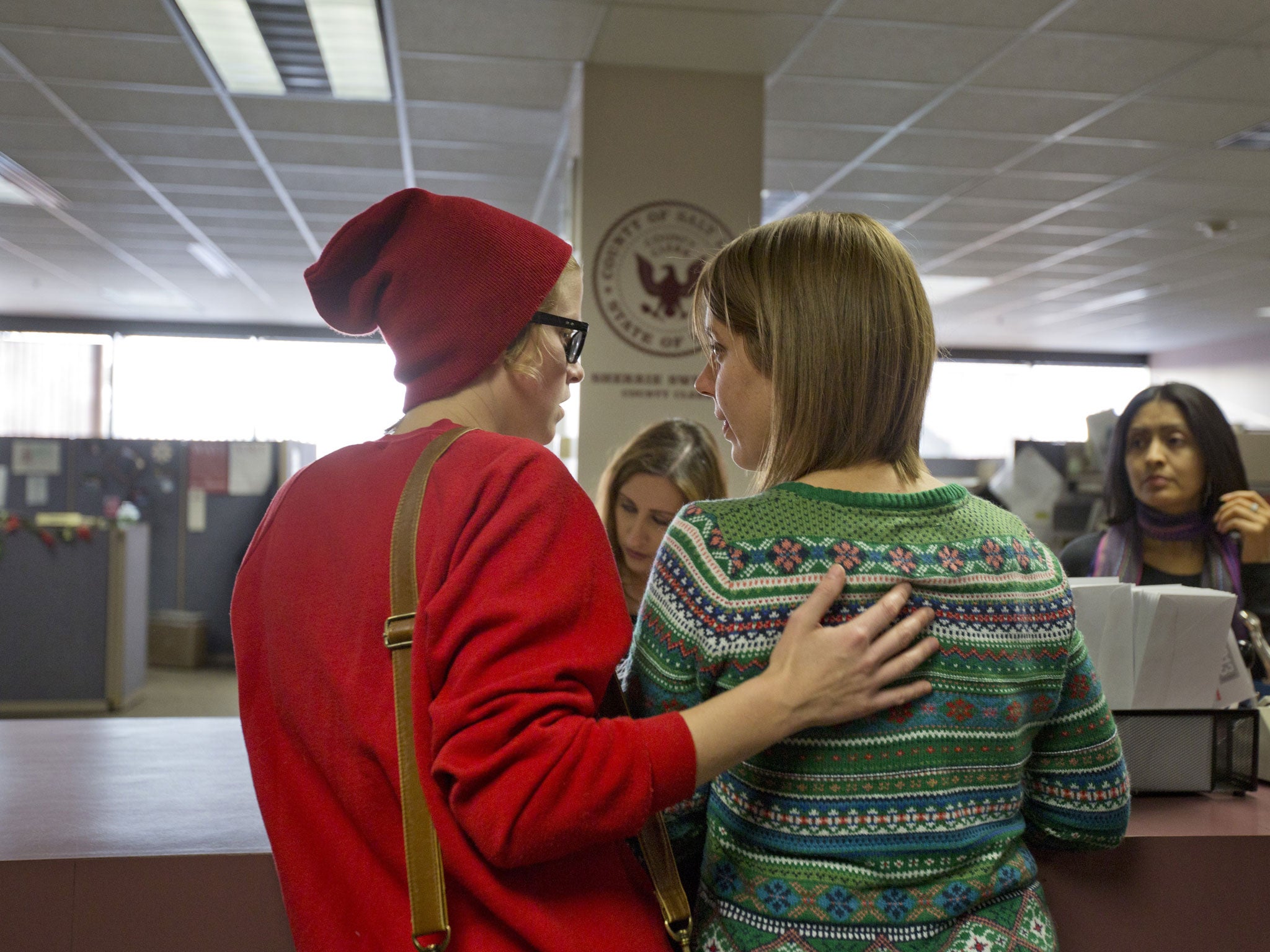 Samantha Christensen, left, and Elise Larsen apply for a marriage license in the Salt Lake County Clerk's Office. On Friday, Utah became the 18th state in the nation to allow gay marriage, however the state is seeking an urgent appeal