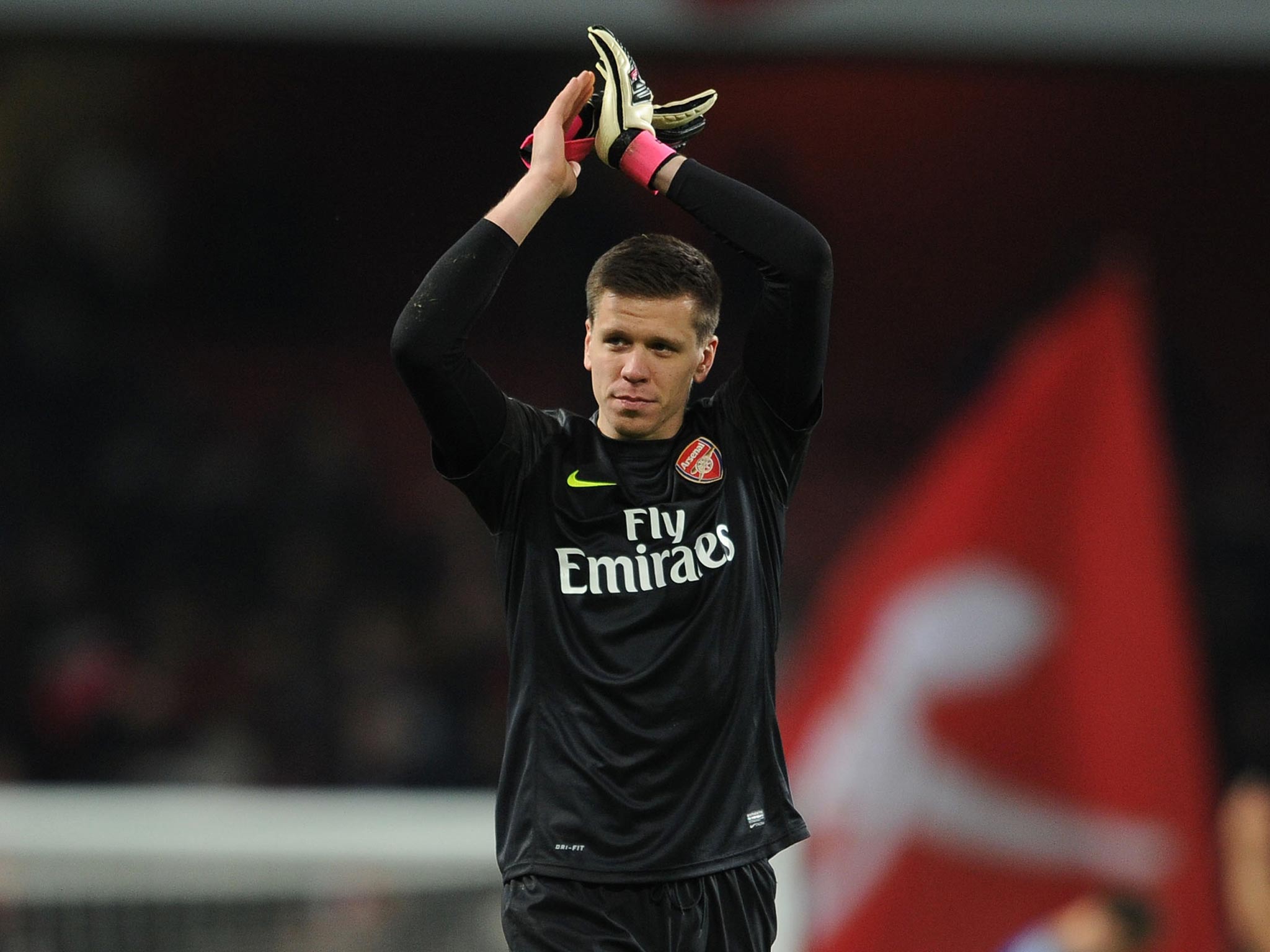 Arsenal goalkeeper Wojciech Szczesny applauds the Gunners fans