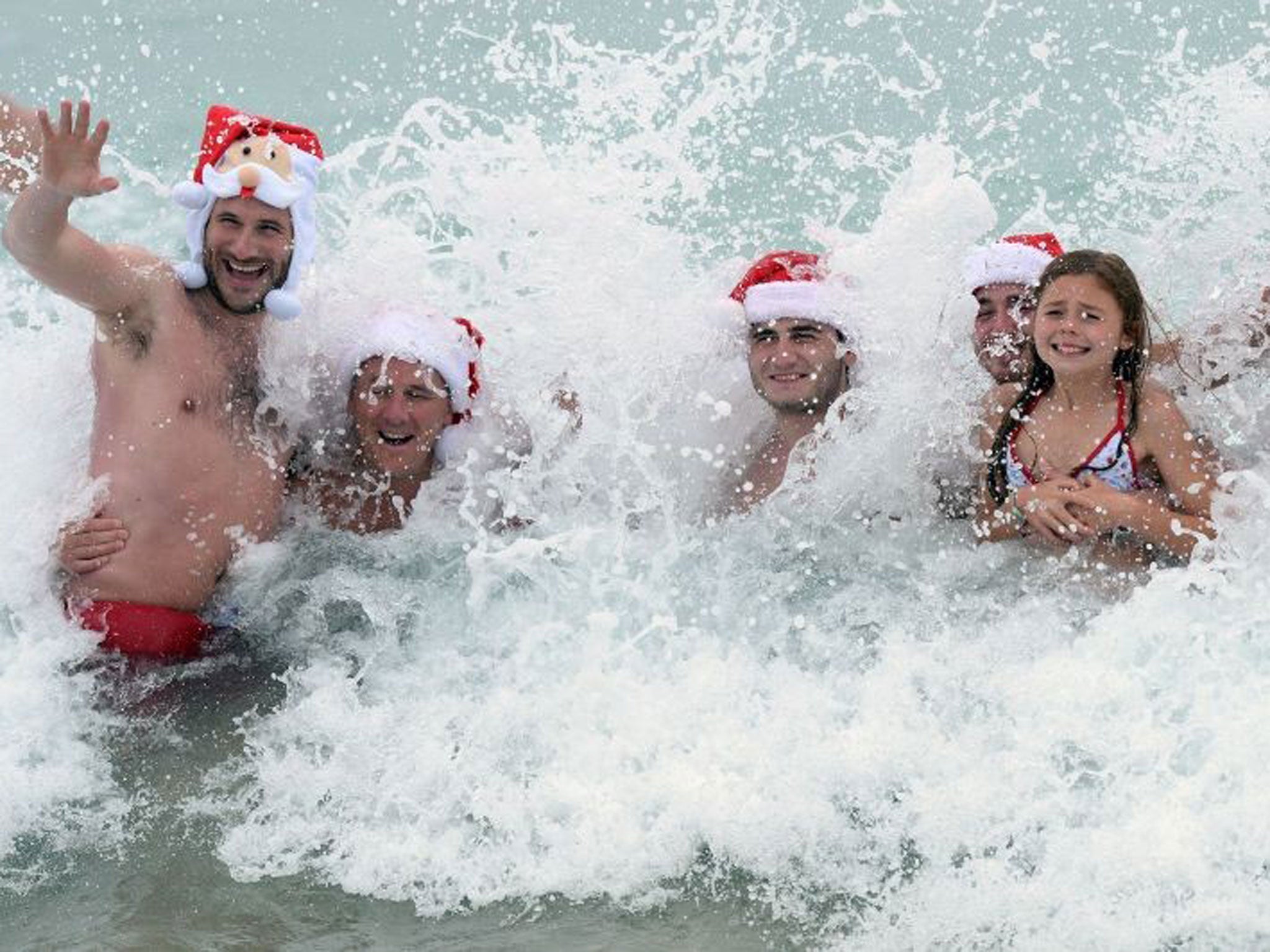 A family enjoy their Christmas day swim at Bondi Beach in Sydney
