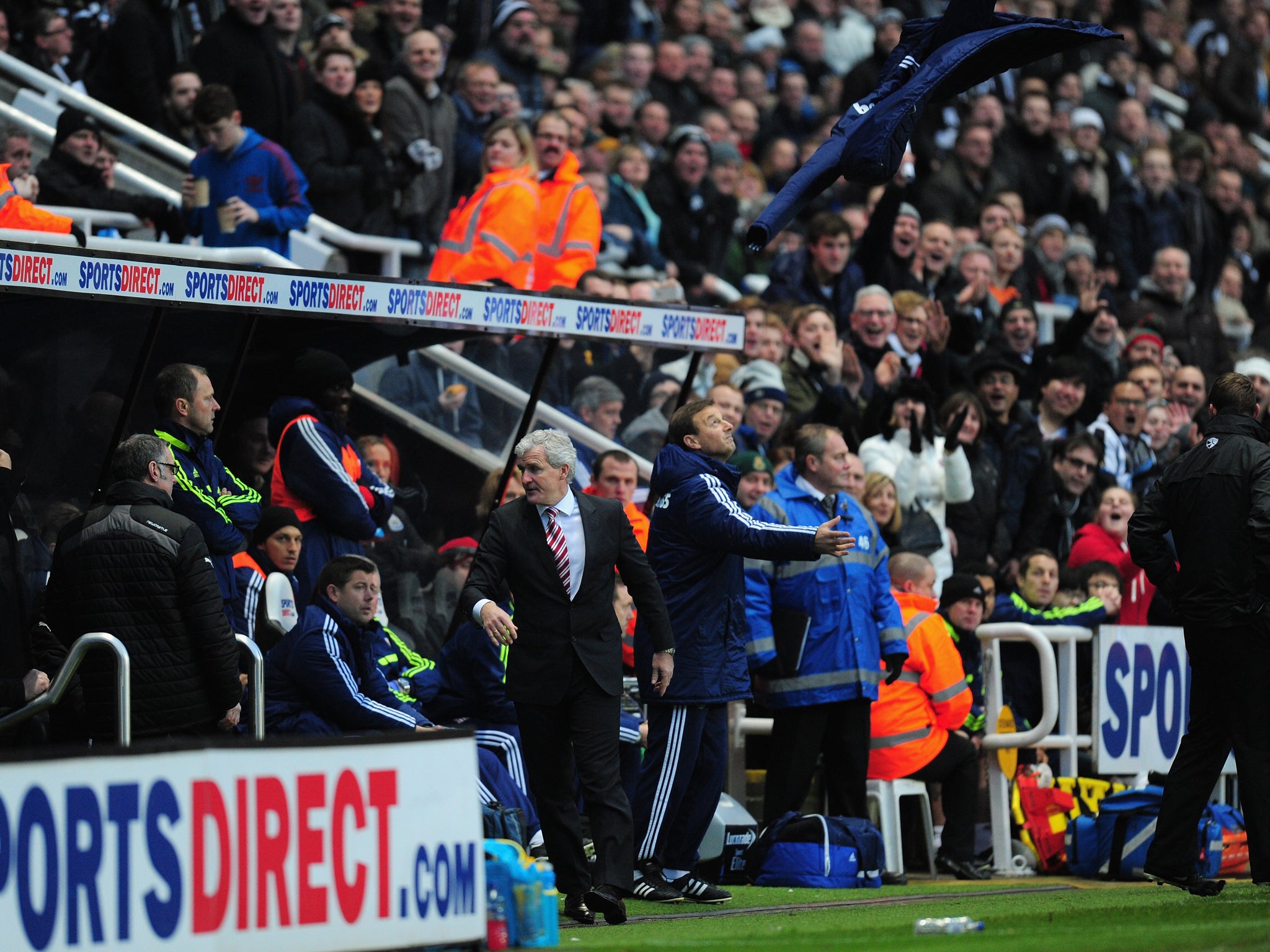 Mark Hughes is sent to the stands after throwing his coat in the air in disgust at the red car shown to Glenn Whelan