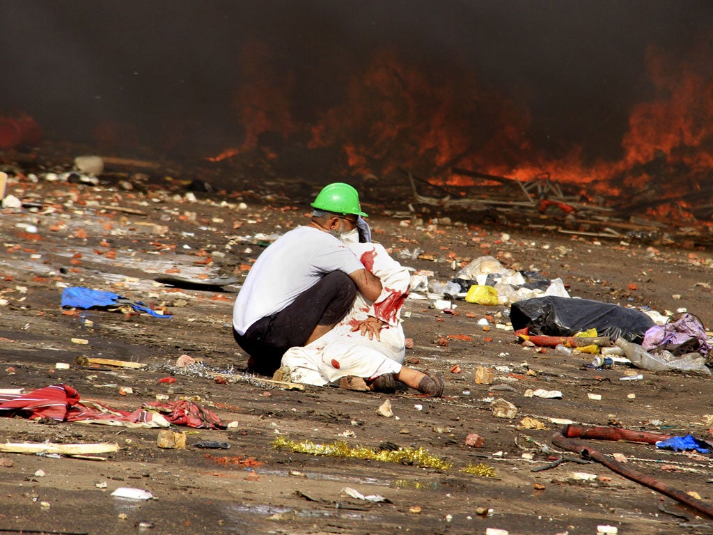 Main picture: a wounded protester is comforted after Egyptian security services opened fire on supporters of ousted president Mohamed Morsi, on a ‘day of shame’ that saw more than 600 people killed