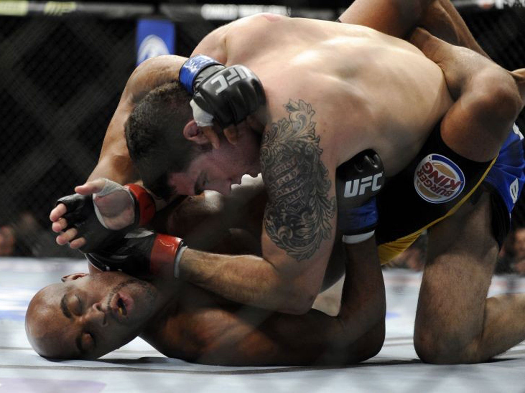 Chris Weidman punches Silva during his final bout at UFC 168. Moments later Weidman won by a technical knockout after the Brazilian's injury