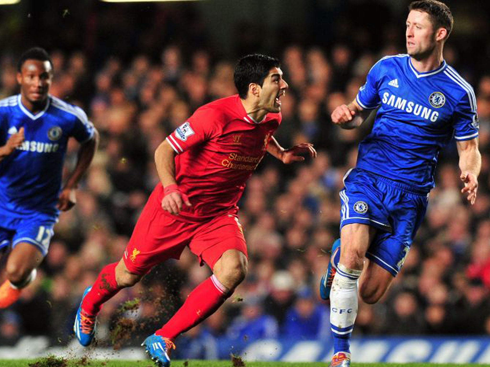 Liverpool's striker Luiz Suarez (centre) clashes with Chelsea defender Gary Cahill when the sides met earlier this season