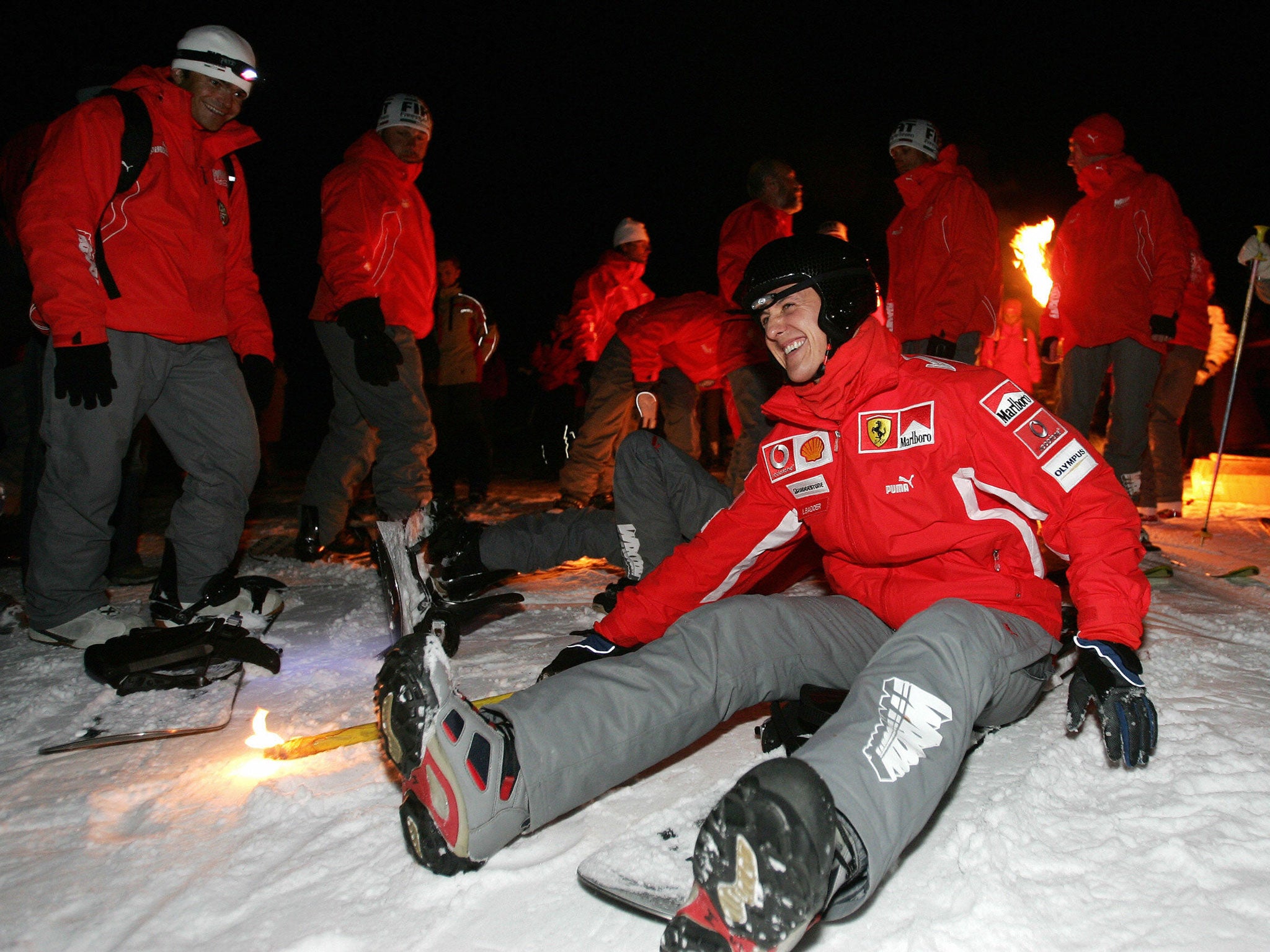 Michael Schumacher jokes on his snowboard during night skiing at Madonna di Campiglio in Italy (AFP/Getty)