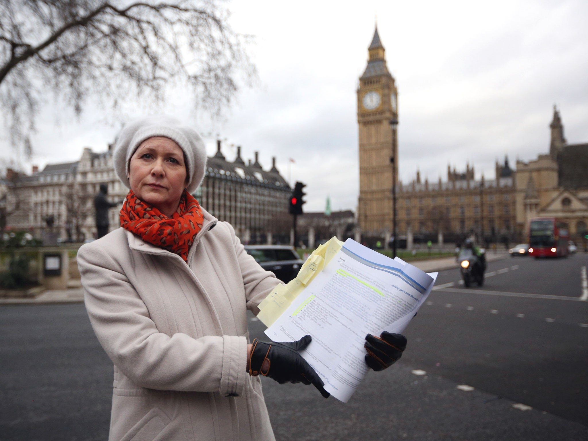 Whistleblower Julie Bailey, of the campaign group 'Cure the NHS' poses outside the Houses of Parliament with a copy of the report of the Mid Staffordshire NHS Trust Foundation Public Inquiry.