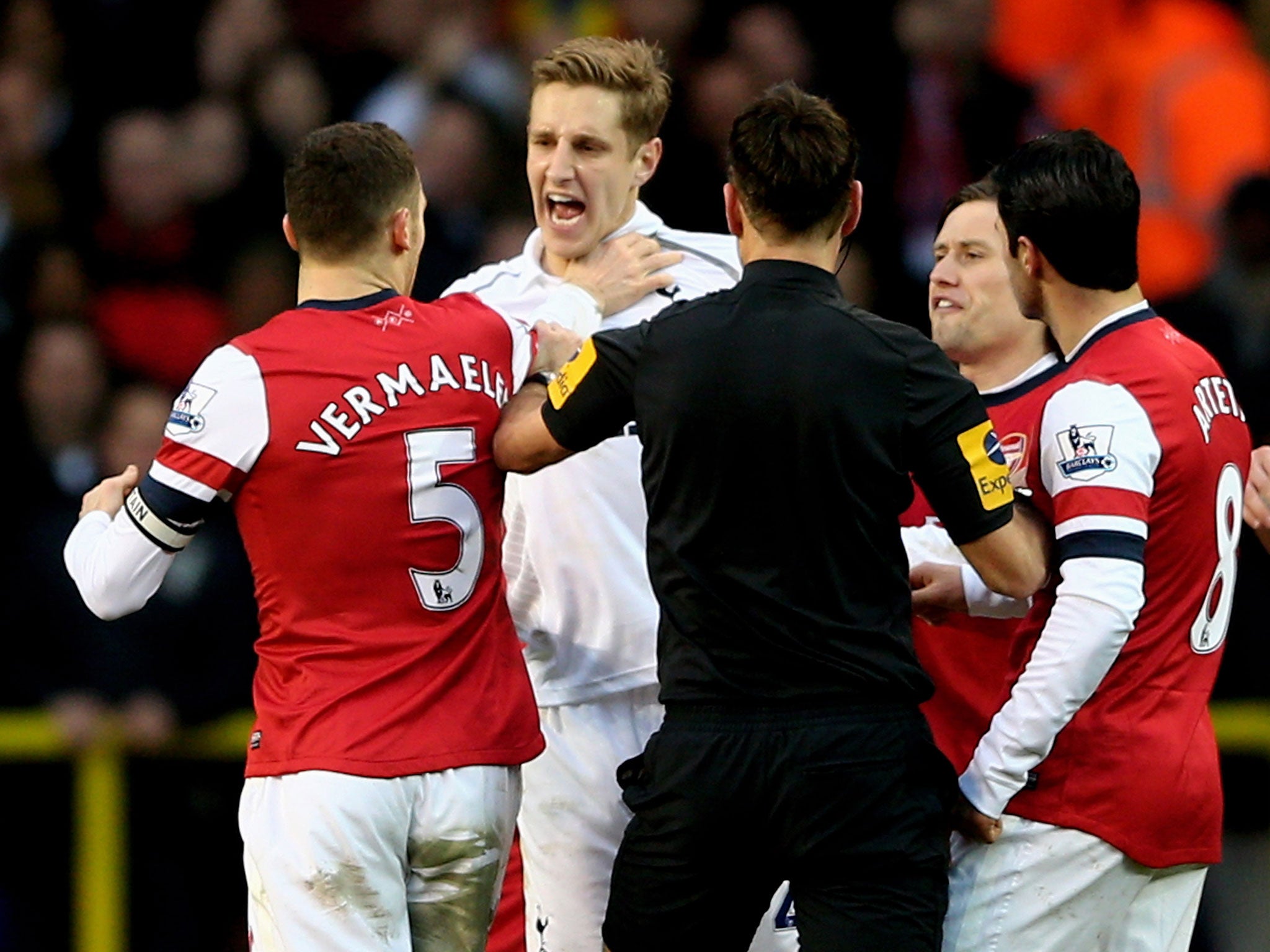 Michael Dawson clashes with Thomas Vermaelen during the north London derby in March 2013