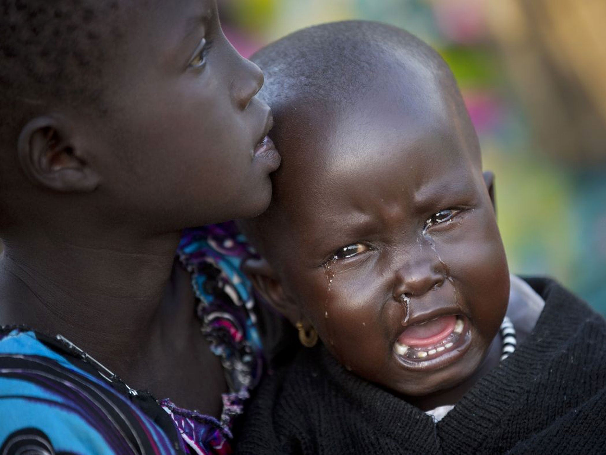 The international Red Cross said that the road from Bor to the nearby Awerial area 'is lined with thousands of people' waiting for boats so they could cross the Nile River and that the gathering of displaced 'is the largest single identified concentration