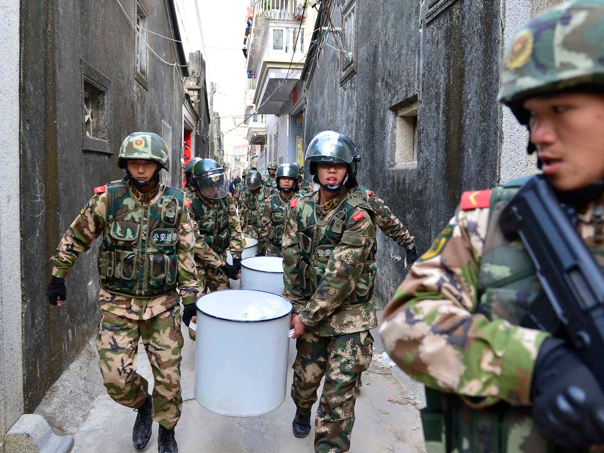 Paramilitary police carry crystal meth at Boshe village, Lufeng, Guangdong province, where they seized nearly three tonnes of the drug and arrested 182