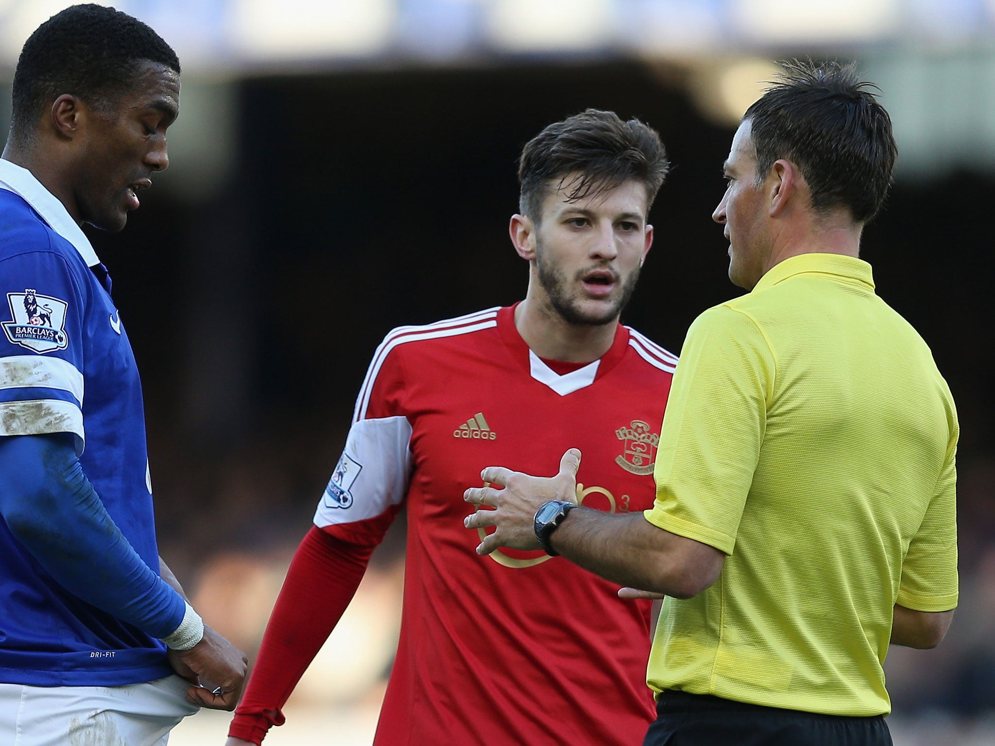 Everton's Sylvain Distin (left), Adam Lallana (centre) and Mark Clattenburg (right) during Southampton's 2-1 loss at Goodison Park on 29 December