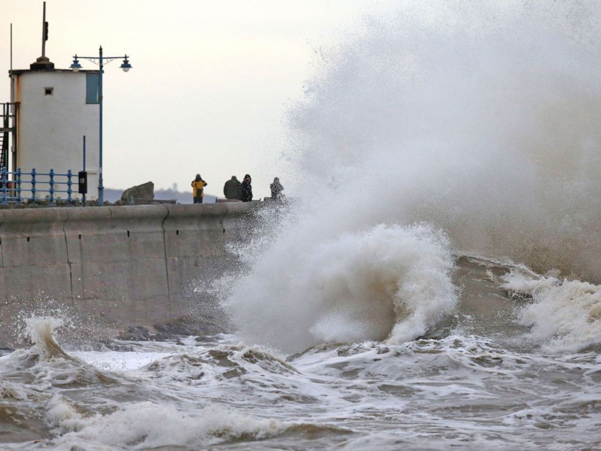 High tide waves break along the seafront at Porthcawl in Mid Glamorgon, Wales