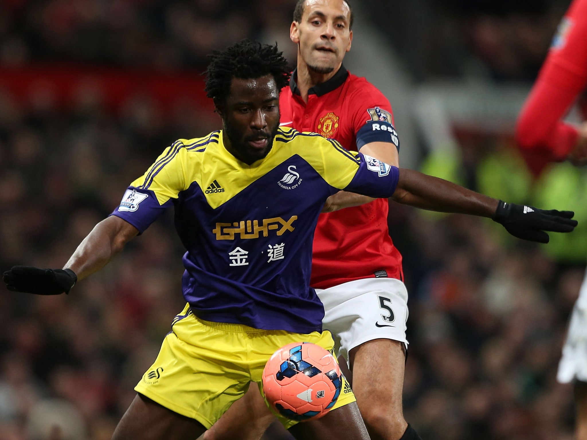 Wilfried Bony fends off Rio Ferdinand at Old Trafford