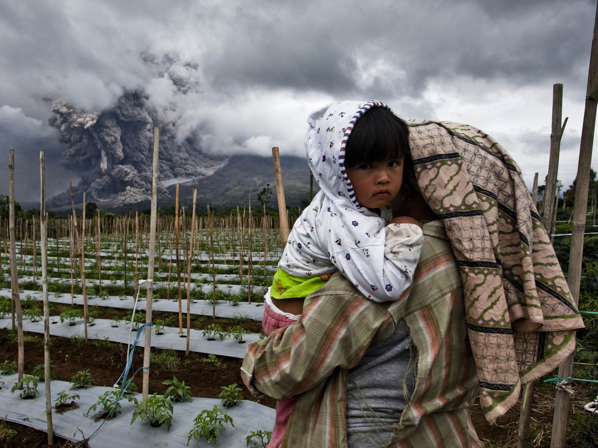 Authorities extended a danger zone around a rumbling volcano in western Indonesia after it spewed blistering gas farther than expected, sending panicked residents streaming down the sides of the mountain