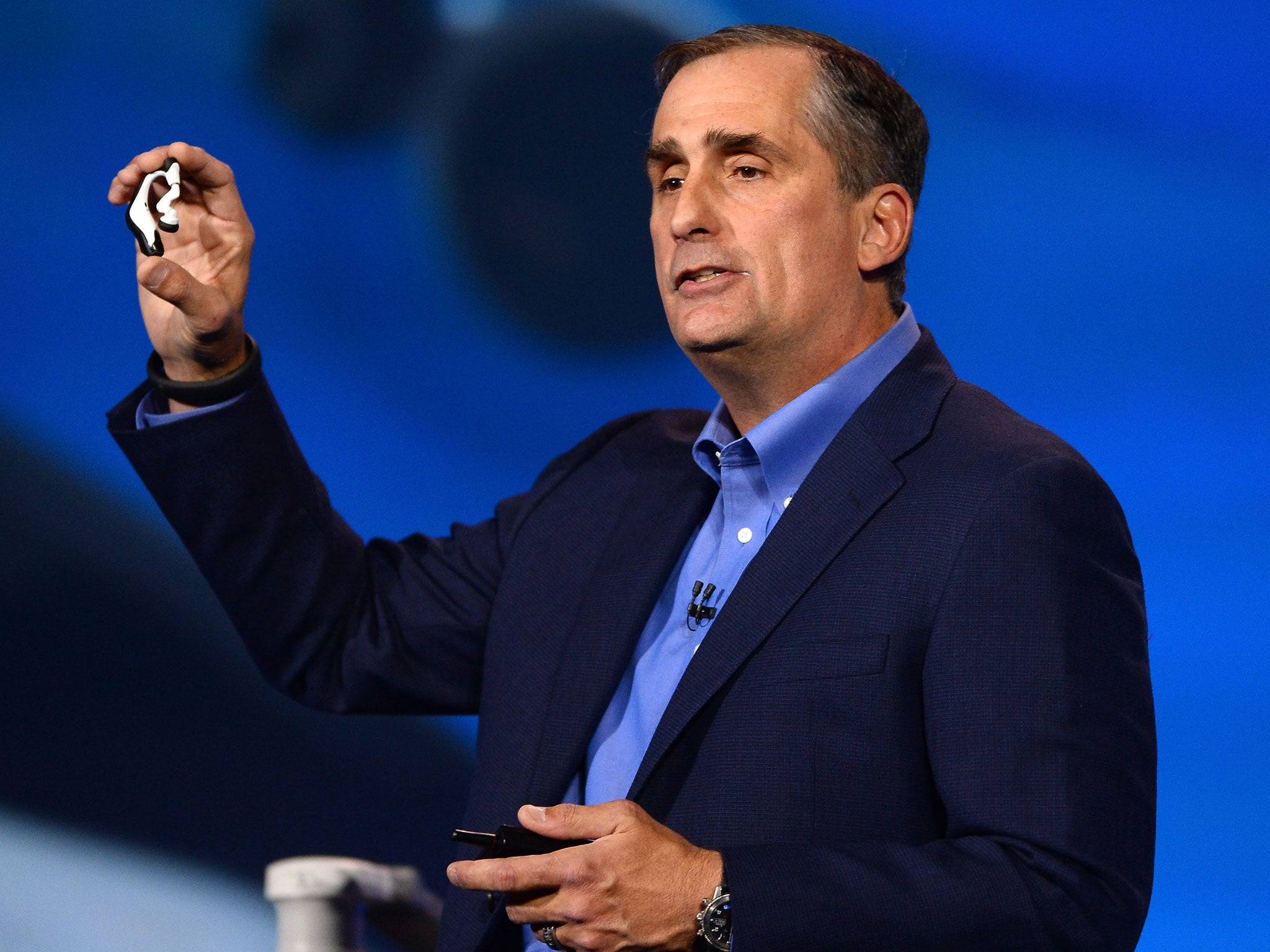 Intel Corp. CEO Brian Krzanich displays the Intel smart headset and earbud designs, providing full stereo audio, heart rate monitor and pulse check, during his keynote address at the 2014 International CES at The Venetian hote