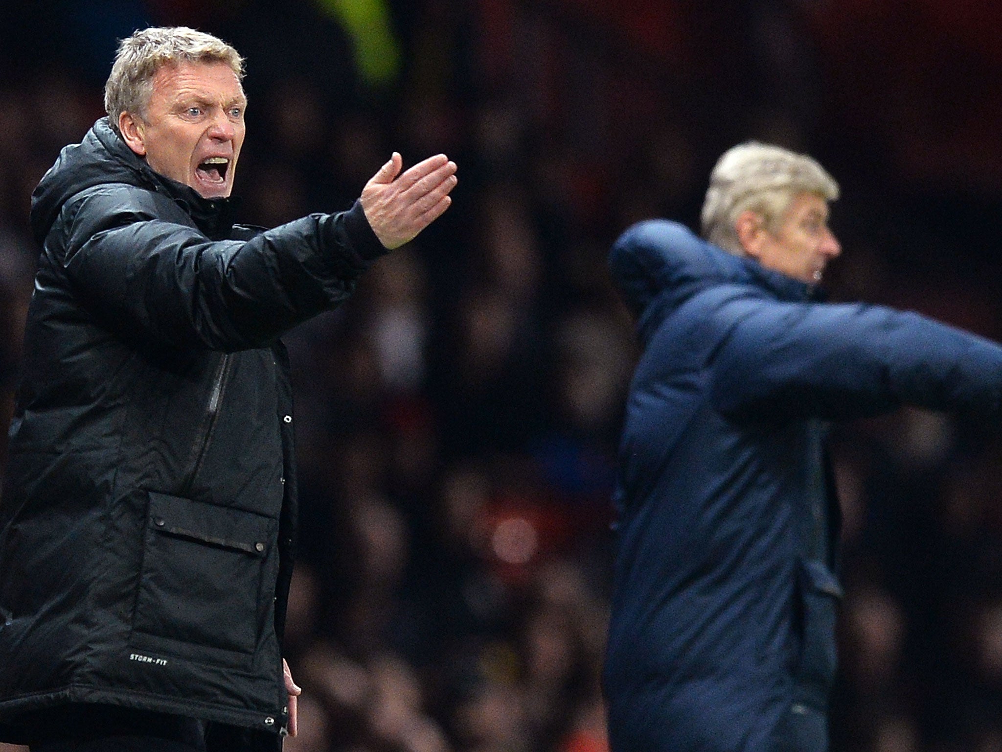 Manchester United manager David Moyes and Arsenal manager Arsene Wenger gesture on the sidelines