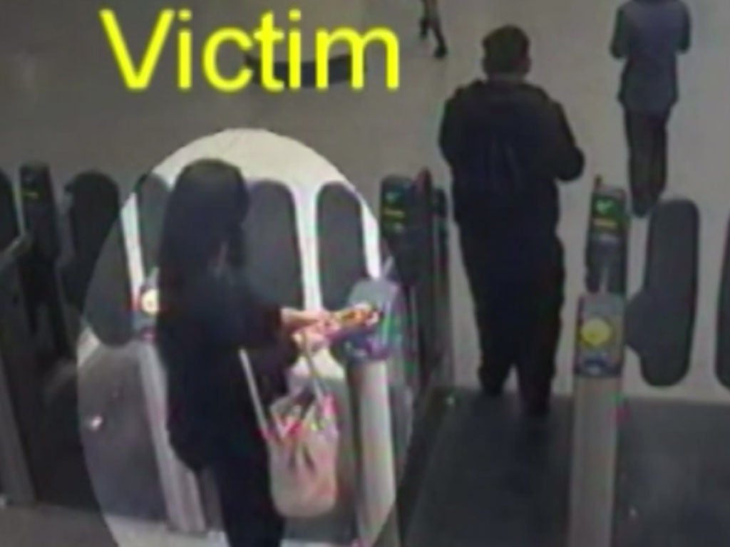 The victim coming through the ticket barrier at Stratford followed by the suspect