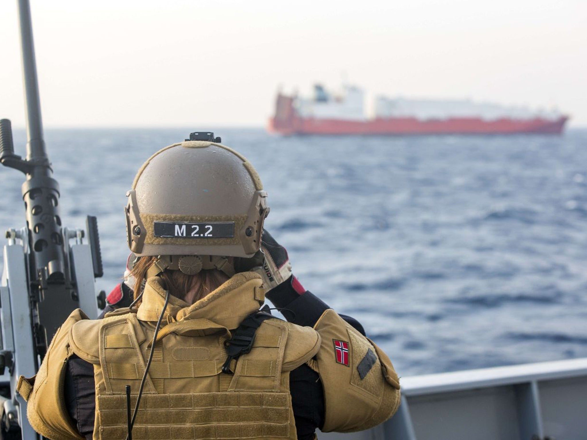 A Norwegian soldier stands guard on one of four Danish and Norwegian vessels deployed to bring Syria's chemical agents to destruction