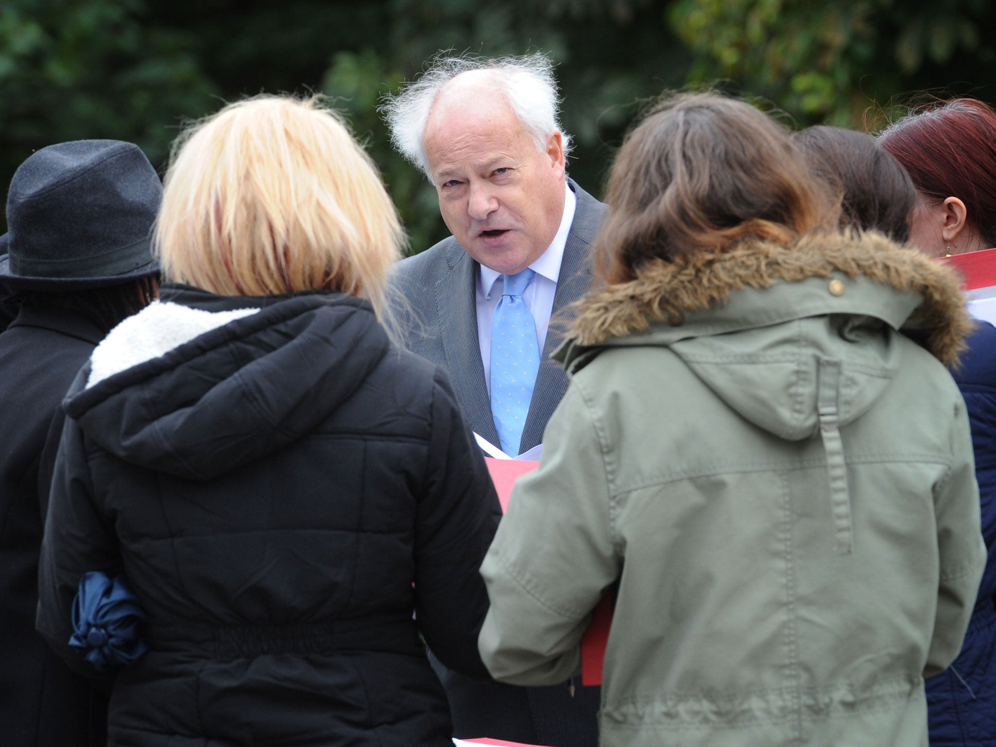 The jury, accompanied by Judge Keith Cutler, in the inquest into the death of Mark Duggan visit the scene of his shooting in Tottenham, north London