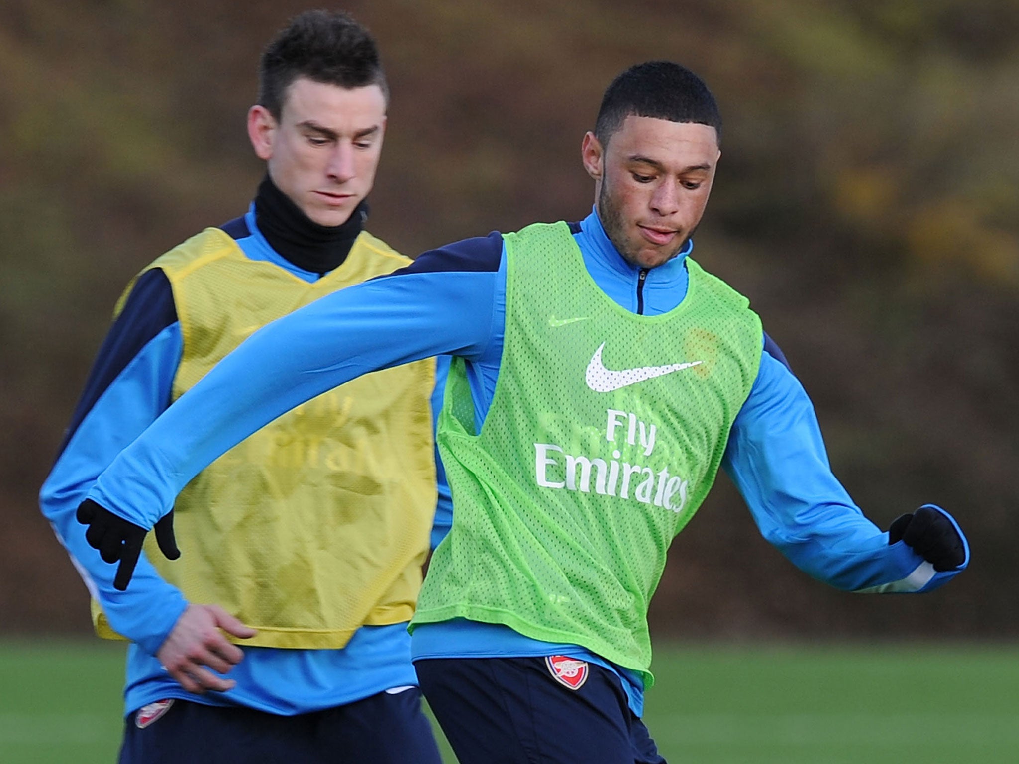 Oxlade Chamberlain fends off defender Laurent Koscielny during Arsenal training on Wednesday